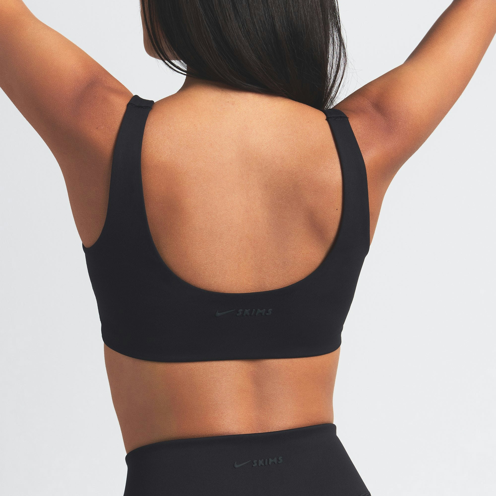 NikeSKIMS MATTE SCOOP NECK BRA | OBSIDIAN ON A MODEL BACK VIEW