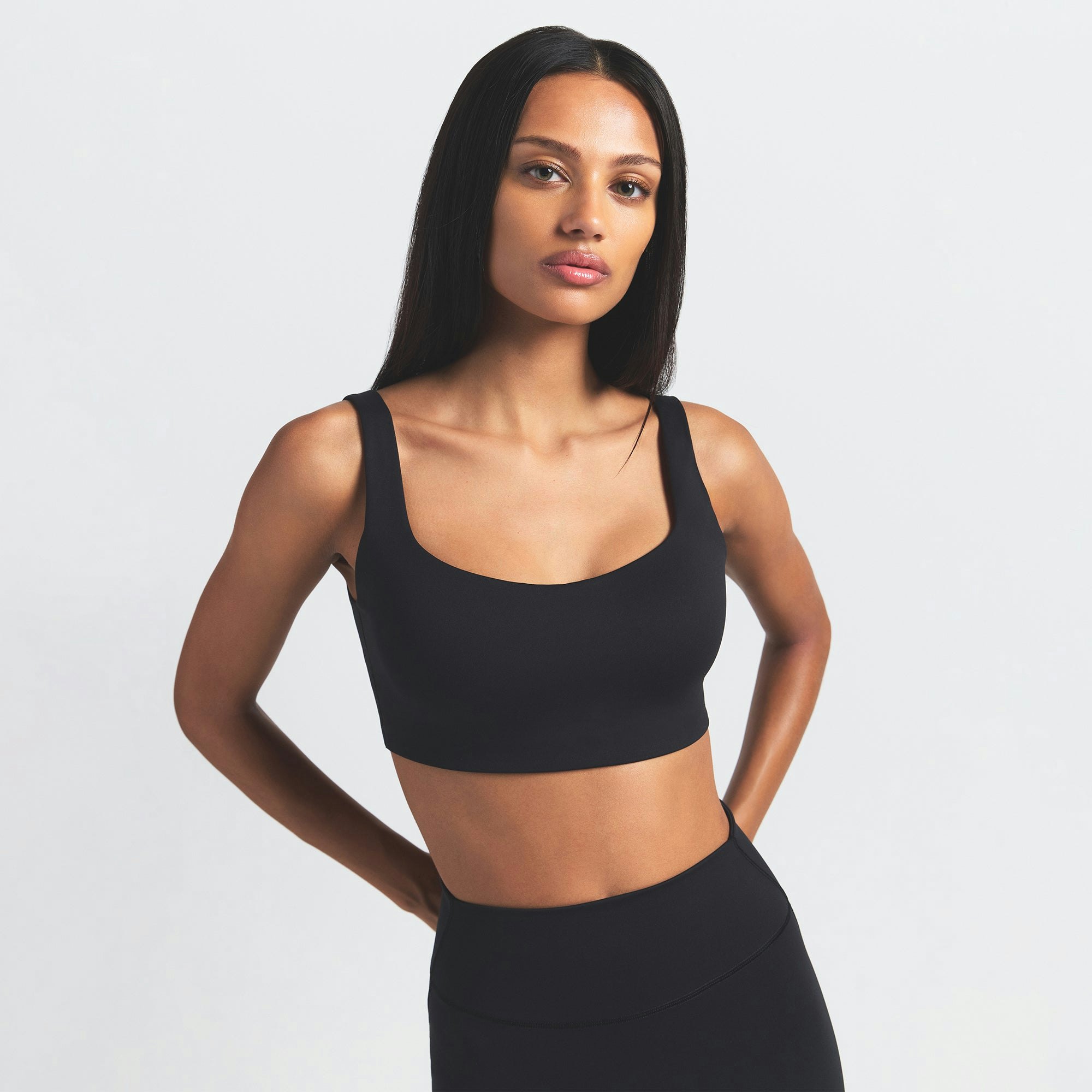 NikeSKIMS MATTE SCOOP NECK BRA | OBSIDIAN ON A MODEL FRONT VIEW