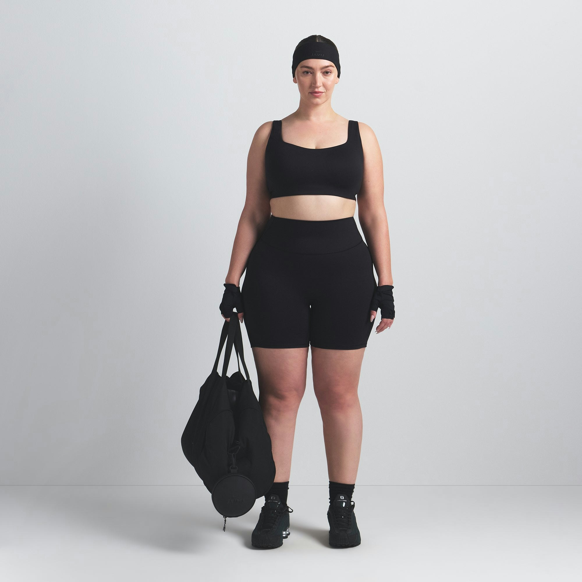 NikeSKIMS MATTE SCOOP NECK BRA | OBSIDIAN ON A MODEL FRONT VIEW