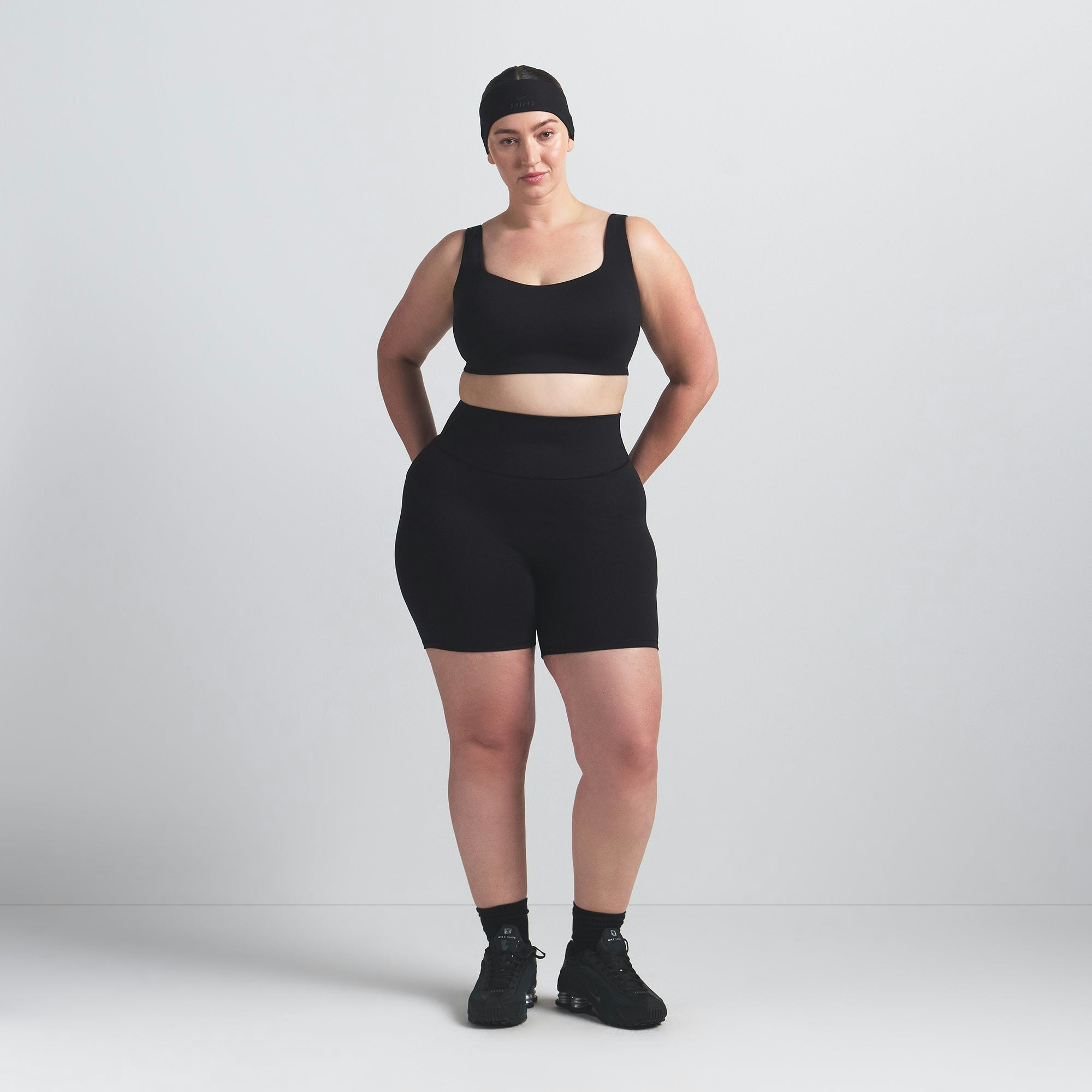 NikeSKIMS MATTE SCOOP NECK BRA | OBSIDIAN ON A MODEL FRONT VIEW