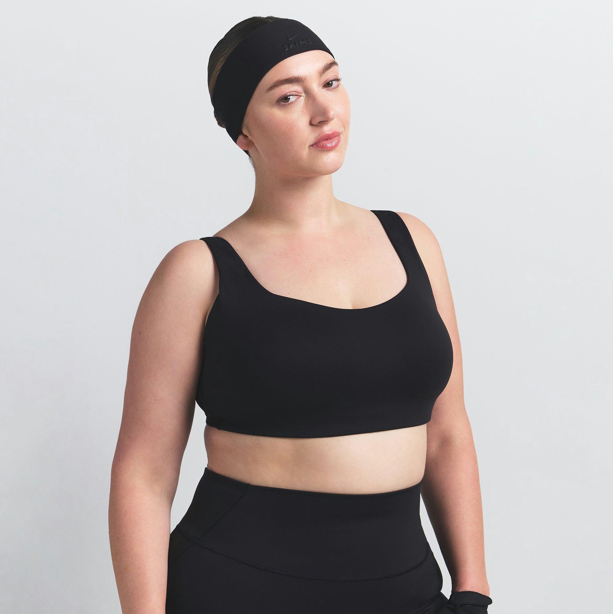 NikeSKIMS MATTE SCOOP NECK BRA | OBSIDIAN ON A MODEL FRONT VIEW