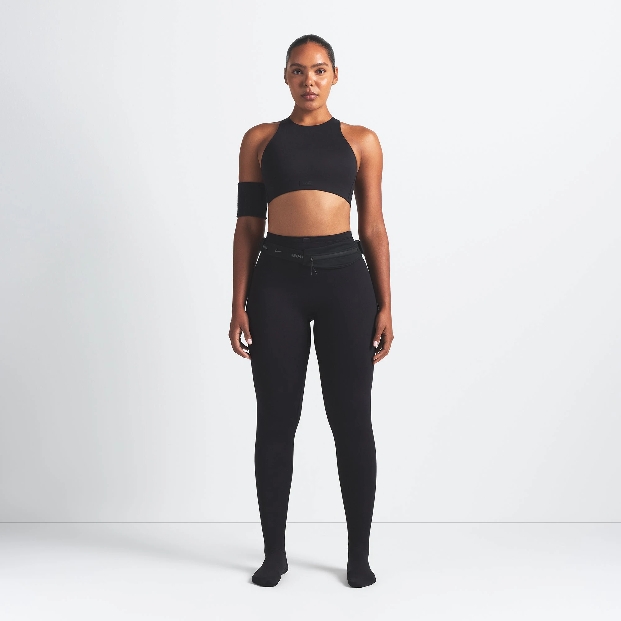 NikeSKIMS MATTE HIGH NECK BRA | OBSIDIAN ON A MODEL FRONT VIEW @ | FOCUS: 0.9, 0.1, 0.7