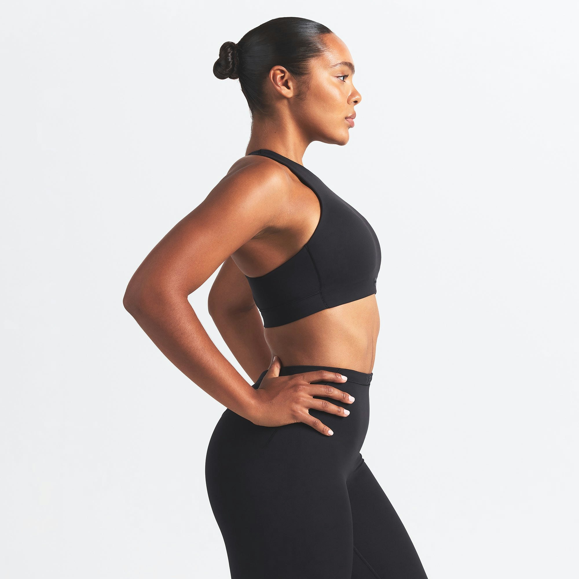 NikeSKIMS MATTE HIGH NECK BRA | OBSIDIAN ON A MODEL SIDE VIEW