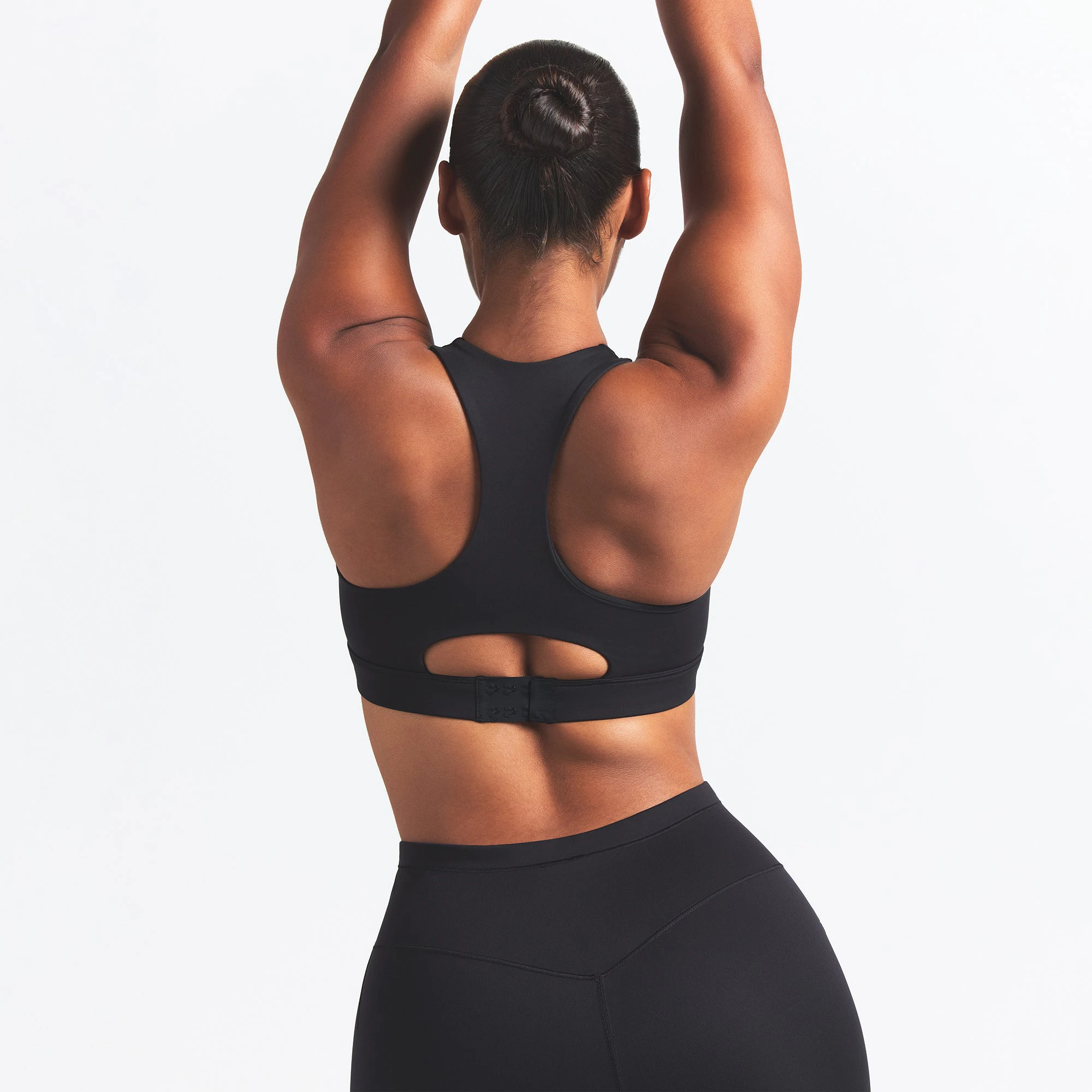 NikeSKIMS MATTE HIGH NECK BRA | OBSIDIAN ON A MODEL BACK VIEW