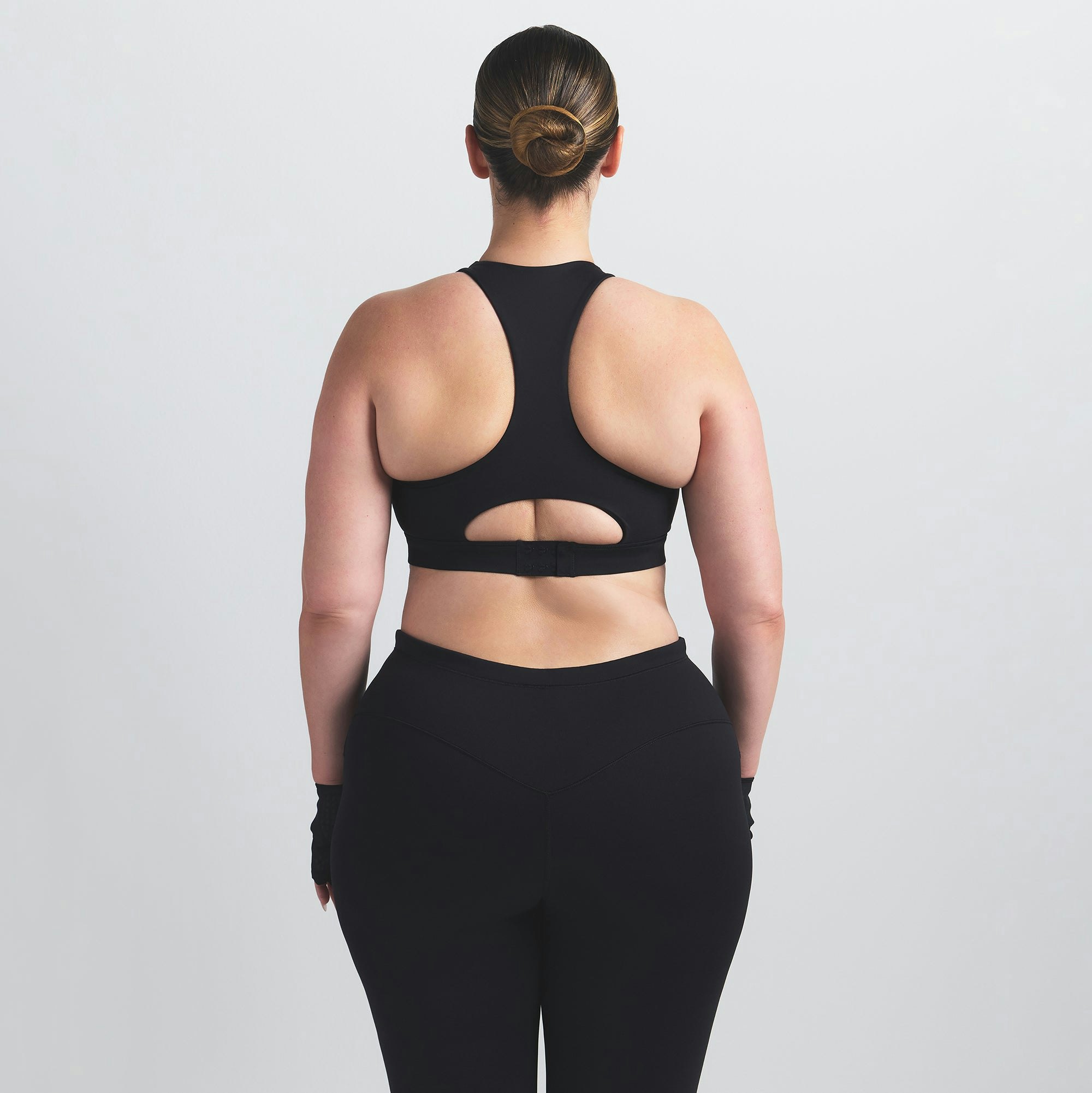 NikeSKIMS MATTE HIGH NECK BRA | OBSIDIAN ON A MODEL BACK VIEW