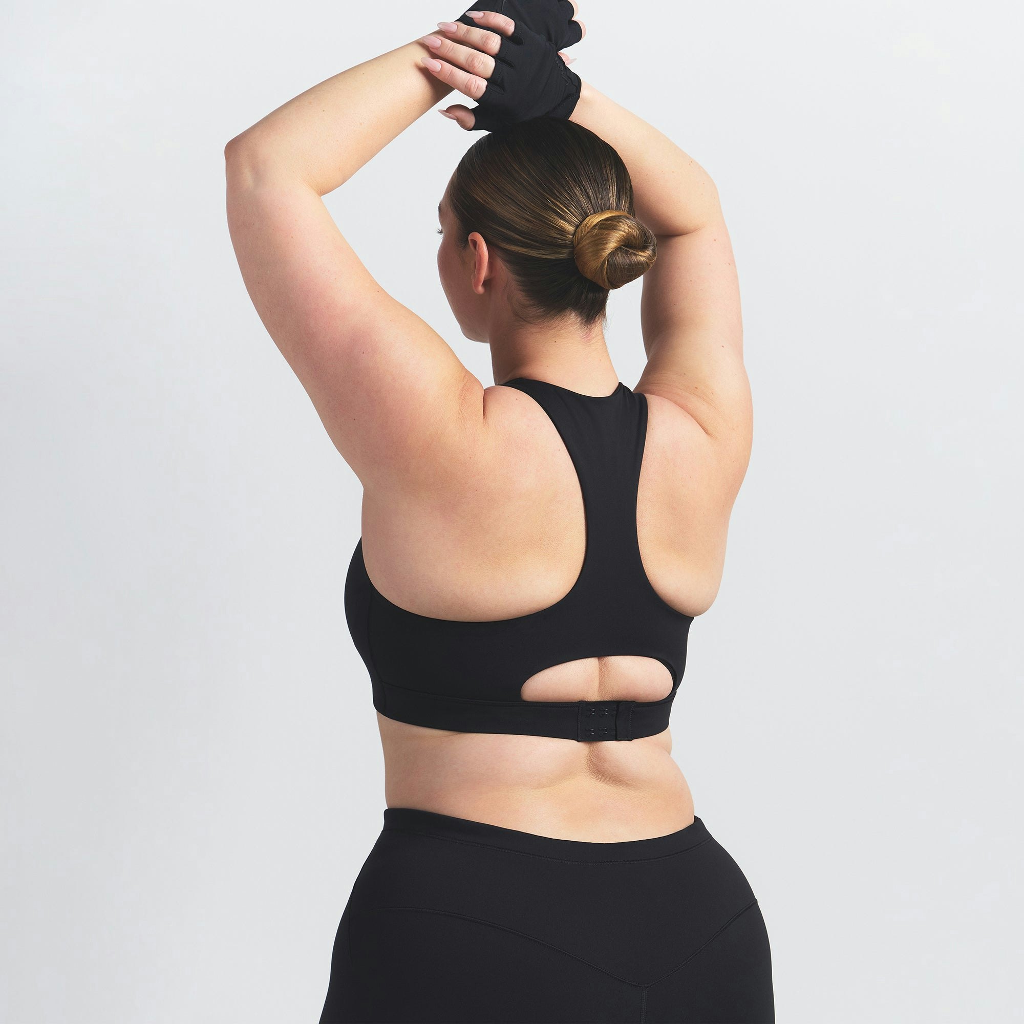 NikeSKIMS MATTE HIGH NECK BRA | OBSIDIAN ON A MODEL BACK VIEW