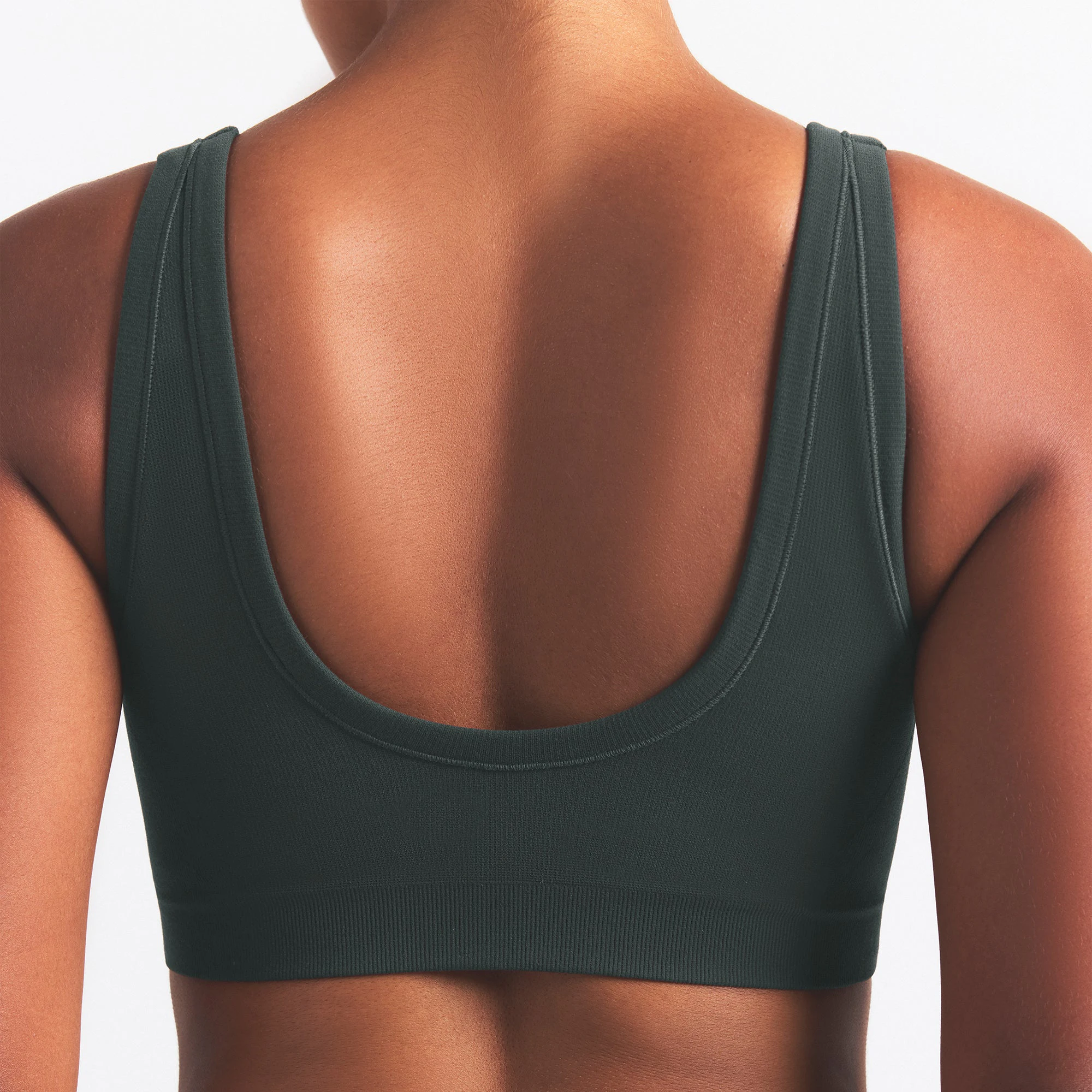 NikeSKIMS VINTAGE SEAMLESS SCOOP NECK BRA | DARK TEAL ON A MODEL SIDE VIEW @ | FOCUS: 0.0, 1.0, 0.9