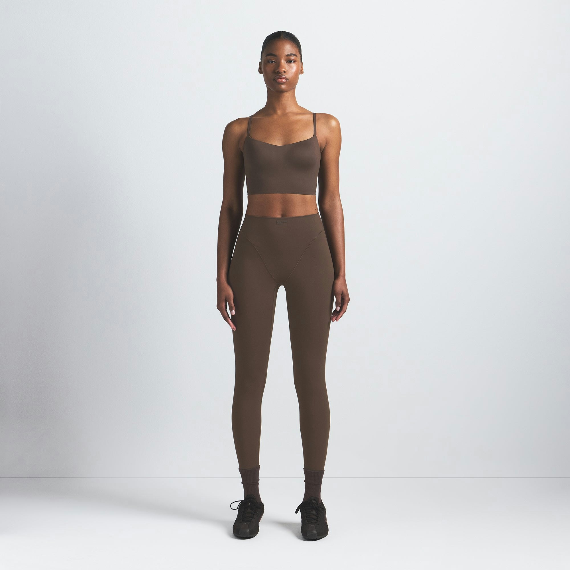 NikeSKIMS MATTE CAMI BRA TOP | DARK SEPIA ON A MODEL FRONT VIEW