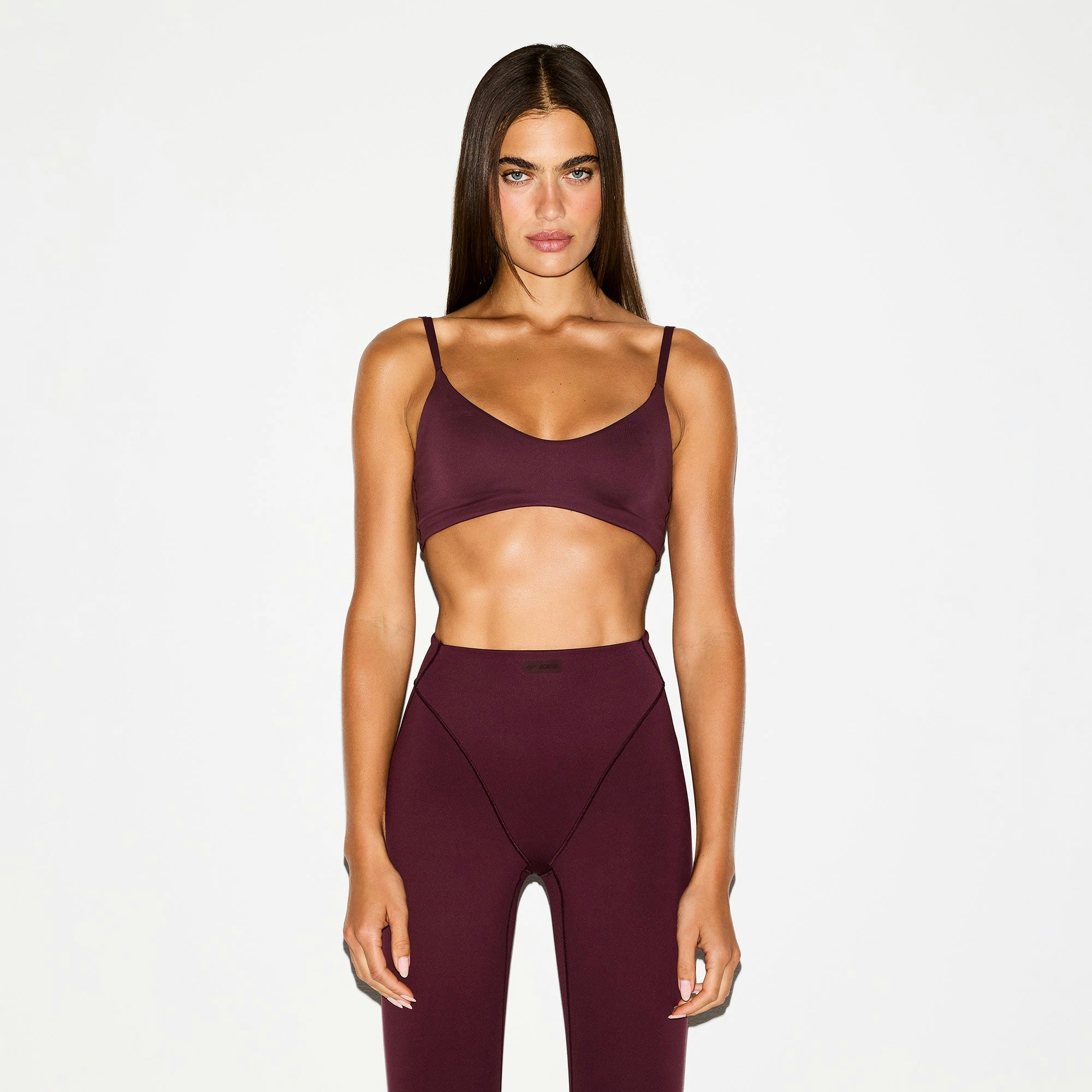 NikeSKIMS MATTE MICRO SCOOP BRA | CURRANT ON A MODEL FRONT VIEW @ | FOCUS: 0.0, 1.0, 0.9
