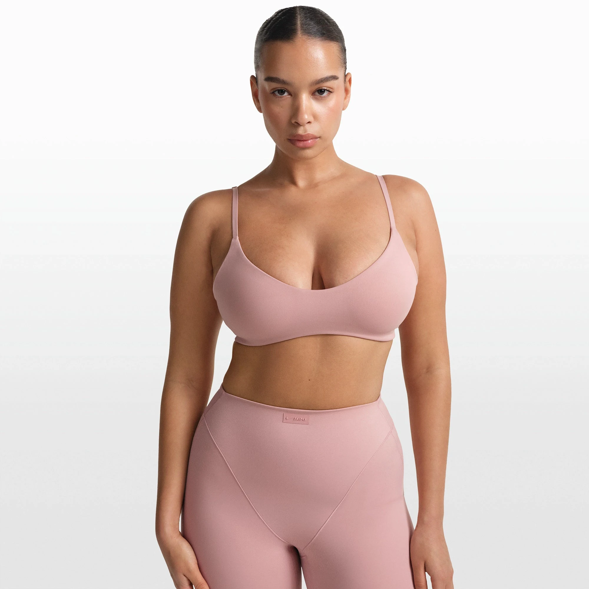 NikeSKIMS MATTE MICRO SCOOP BRA | HIMALAYAN ON A MODEL FRONT VIEW @ | FOCUS: 0.0, 1.0, 0.9