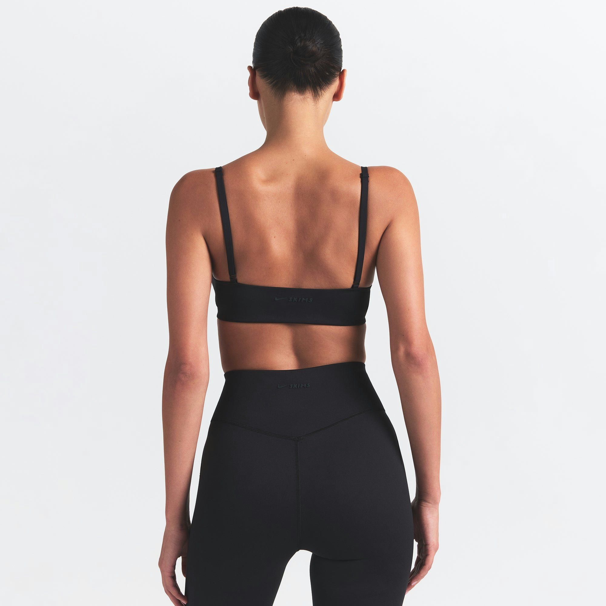 NikeSKIMS MATTE MICRO SCOOP BRA | OBSIDIAN ON A MODEL BACK VIEW