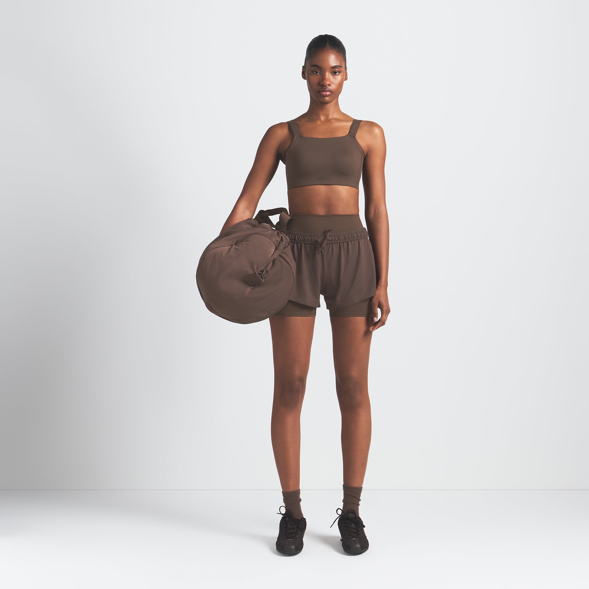 NikeSKIMS MATTE WIDE STRAP BRA | DARK SEPIA ON A MODEL FRONT VIEW @ | FOCUS: 0.9, 0.1, 0.7