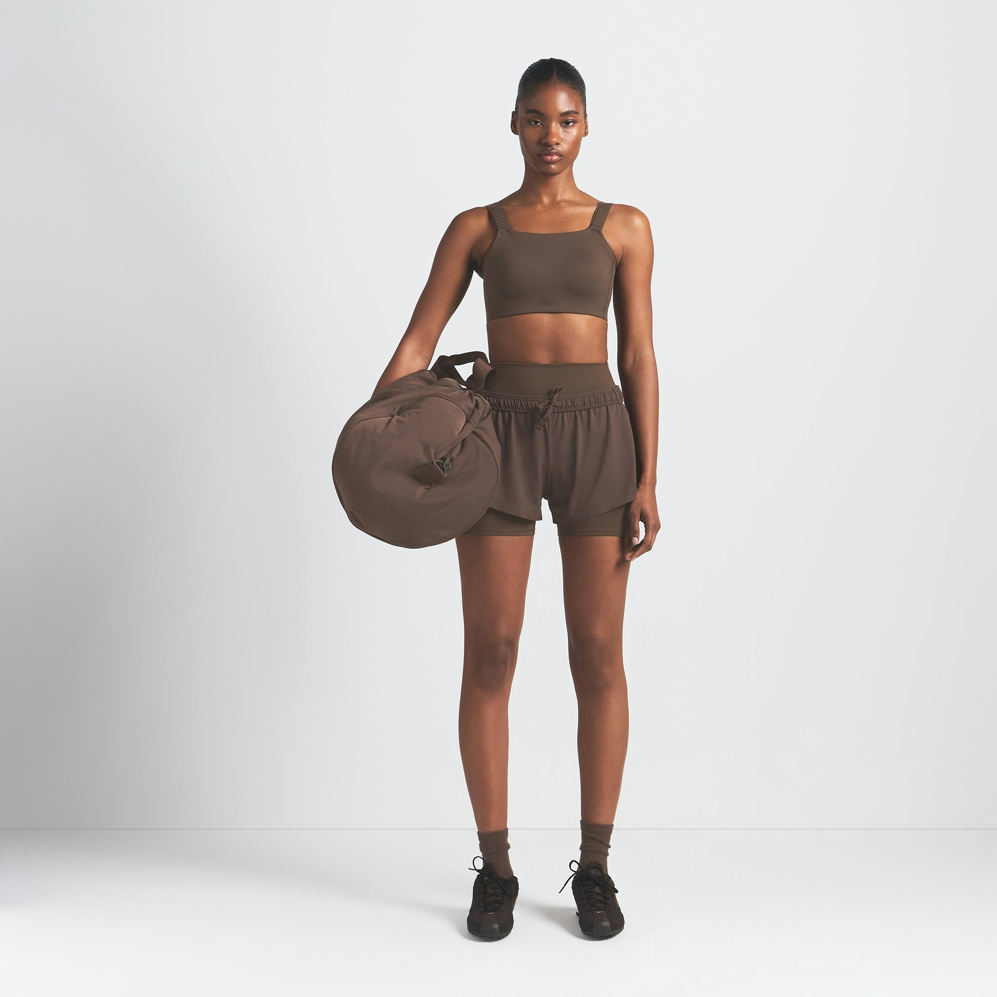 NikeSKIMS MATTE WIDE STRAP BRA | DARK SEPIA ON A MODEL FRONT VIEW @ | FOCUS: 0.9, 0.1, 0.7