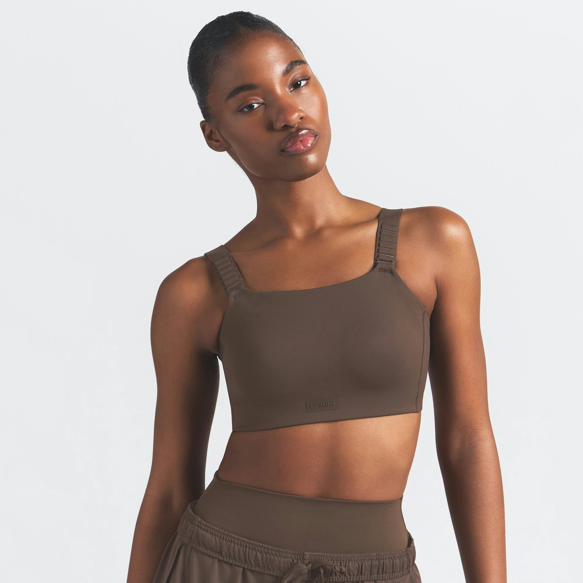 NikeSKIMS MATTE WIDE STRAP BRA | DARK SEPIA ON A MODEL FRONT VIEW