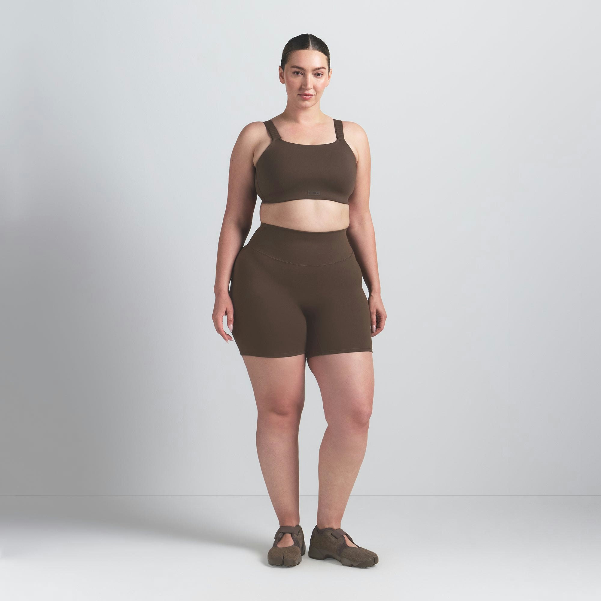 NikeSKIMS MATTE WIDE STRAP BRA | DARK SEPIA ON A MODEL FRONT VIEW