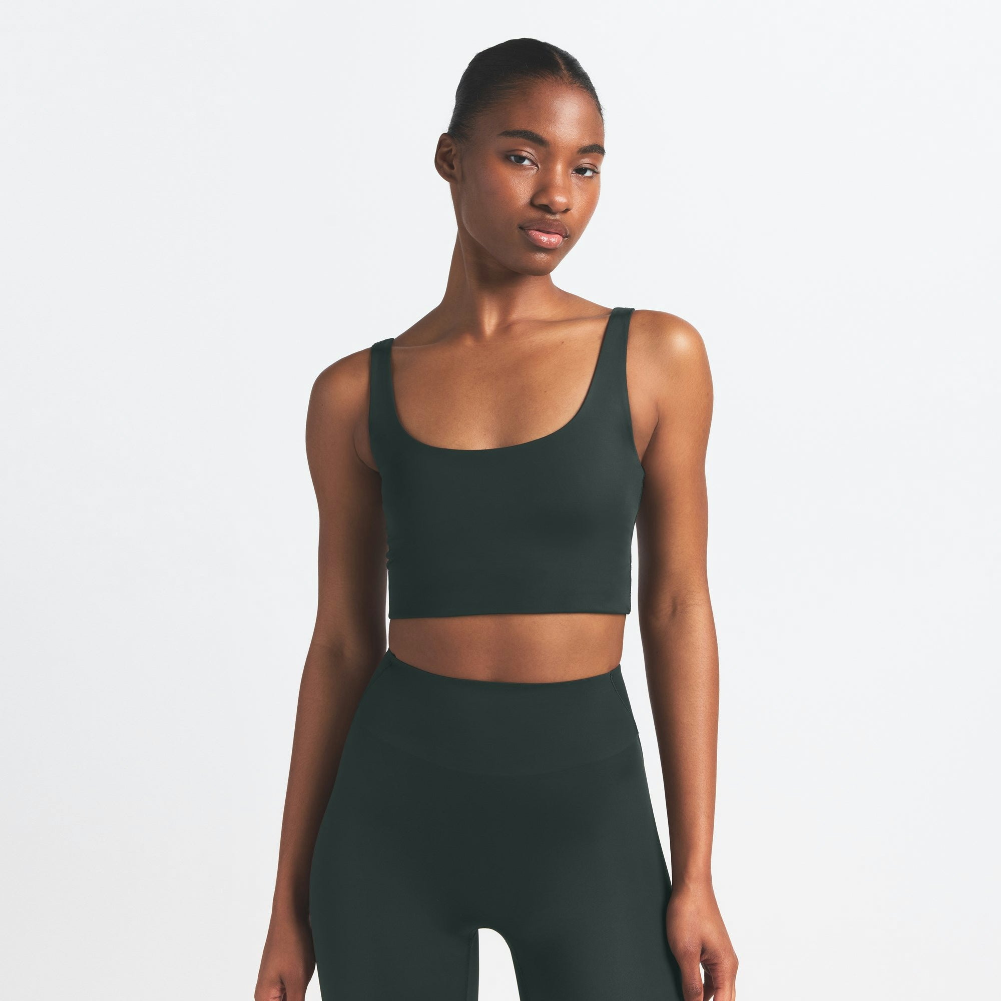 NikeSKIMS SHINE SCOOP NECK BRA TOP | DARK TEAL ON A MODEL SIDE VIEW @ | FOCUS: 0.0, 1.0, 0.9