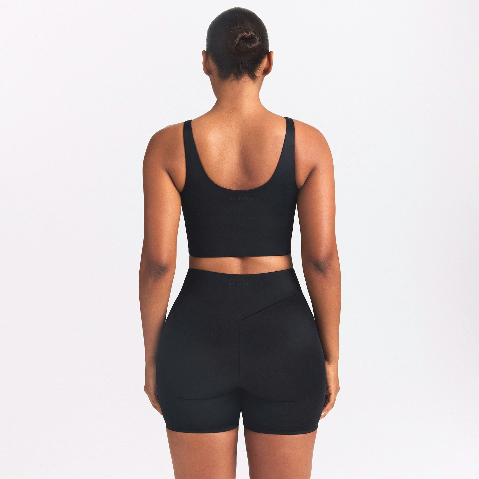 NikeSKIMS SHINE SCOOP NECK BRA TOP | OBSIDIAN ON A MODEL SIDE VIEW
