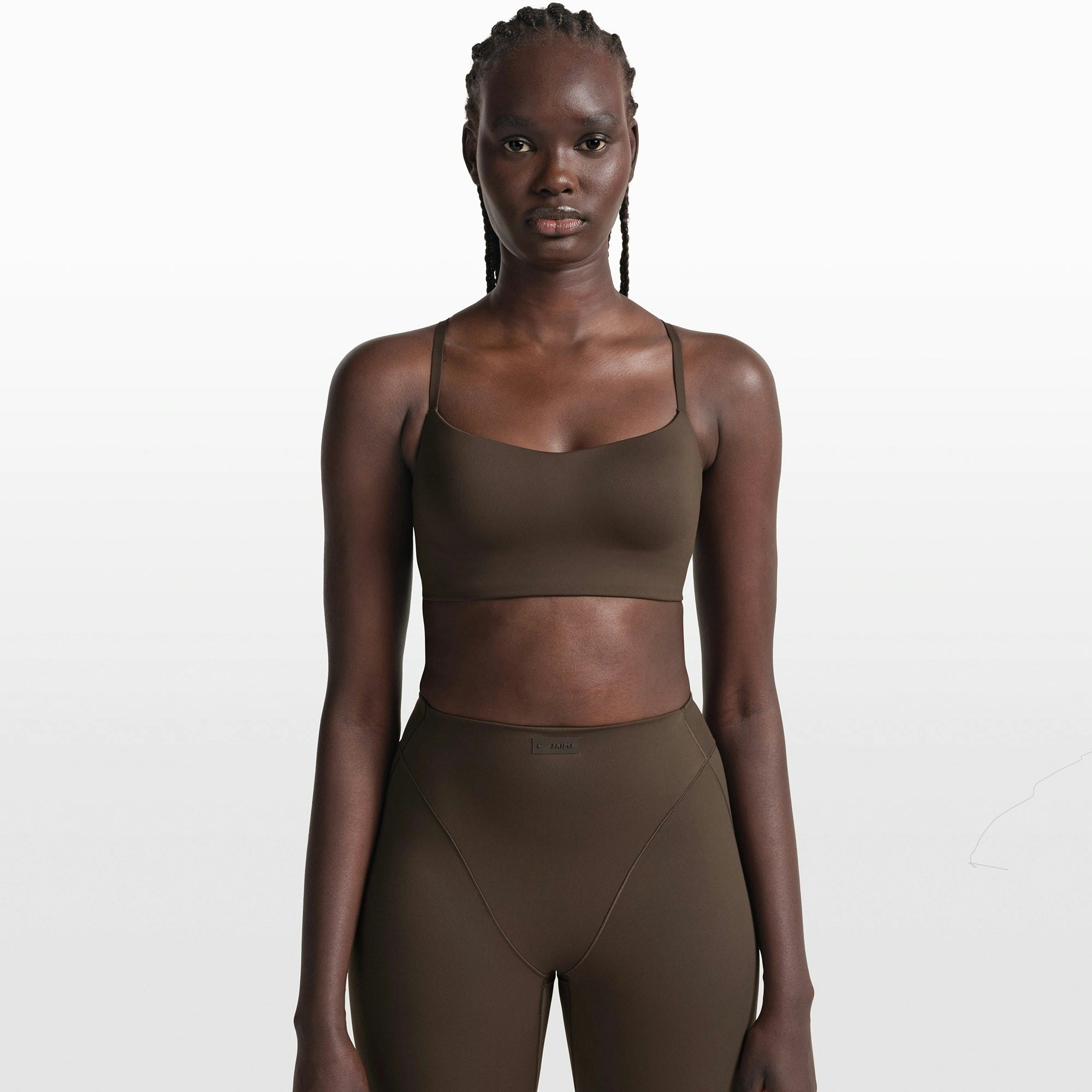 NikeSKIMS MATTE CONTOUR CAMI BRA | DARK SEPIA ON A MODEL FRONT VIEW @ | FOCUS: 0.0, 1.0, 0.9