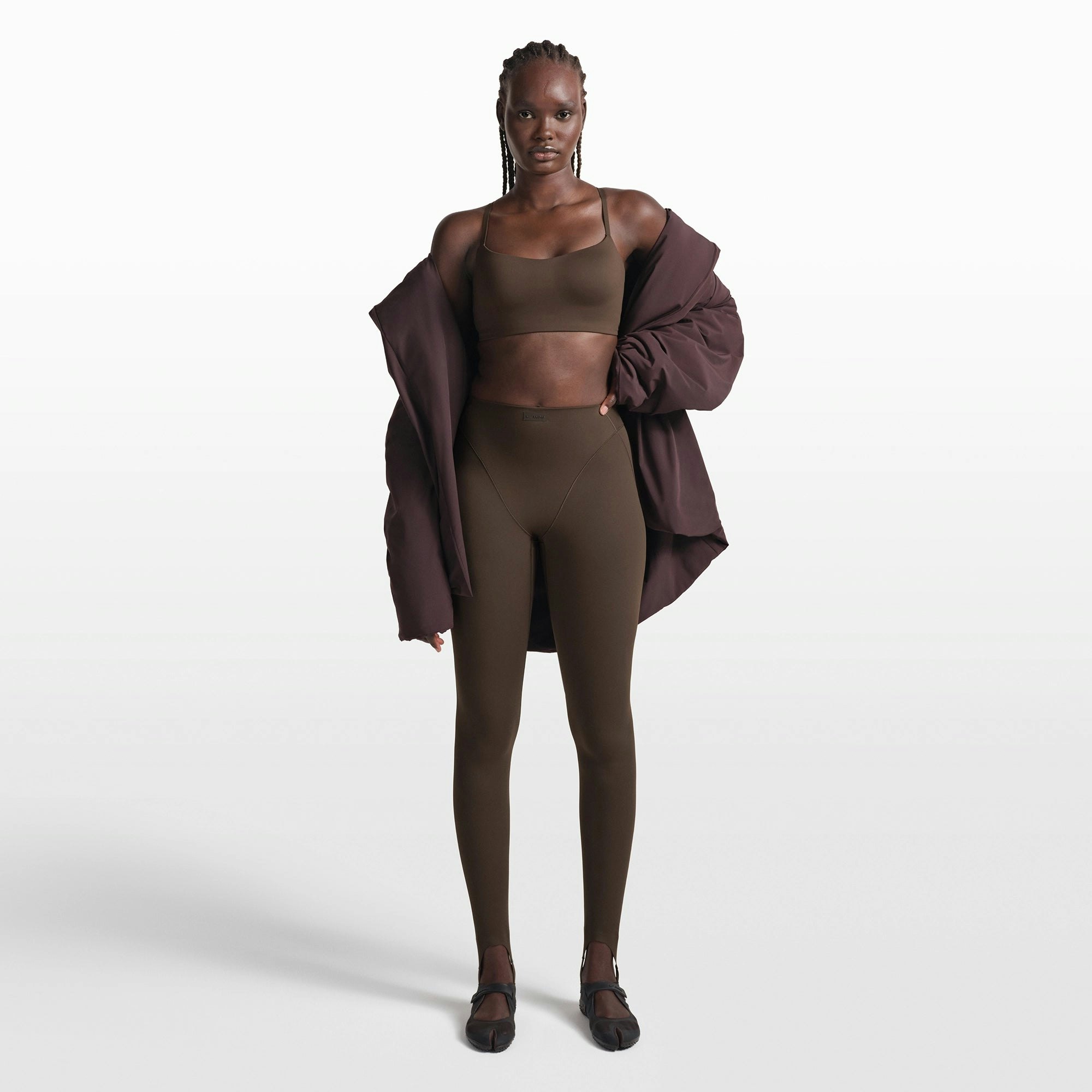 NikeSKIMS MATTE CONTOUR CAMI BRA | DARK SEPIA ON A MODEL FRONT VIEW @ | FOCUS: 0.0, 1.0, 0.9