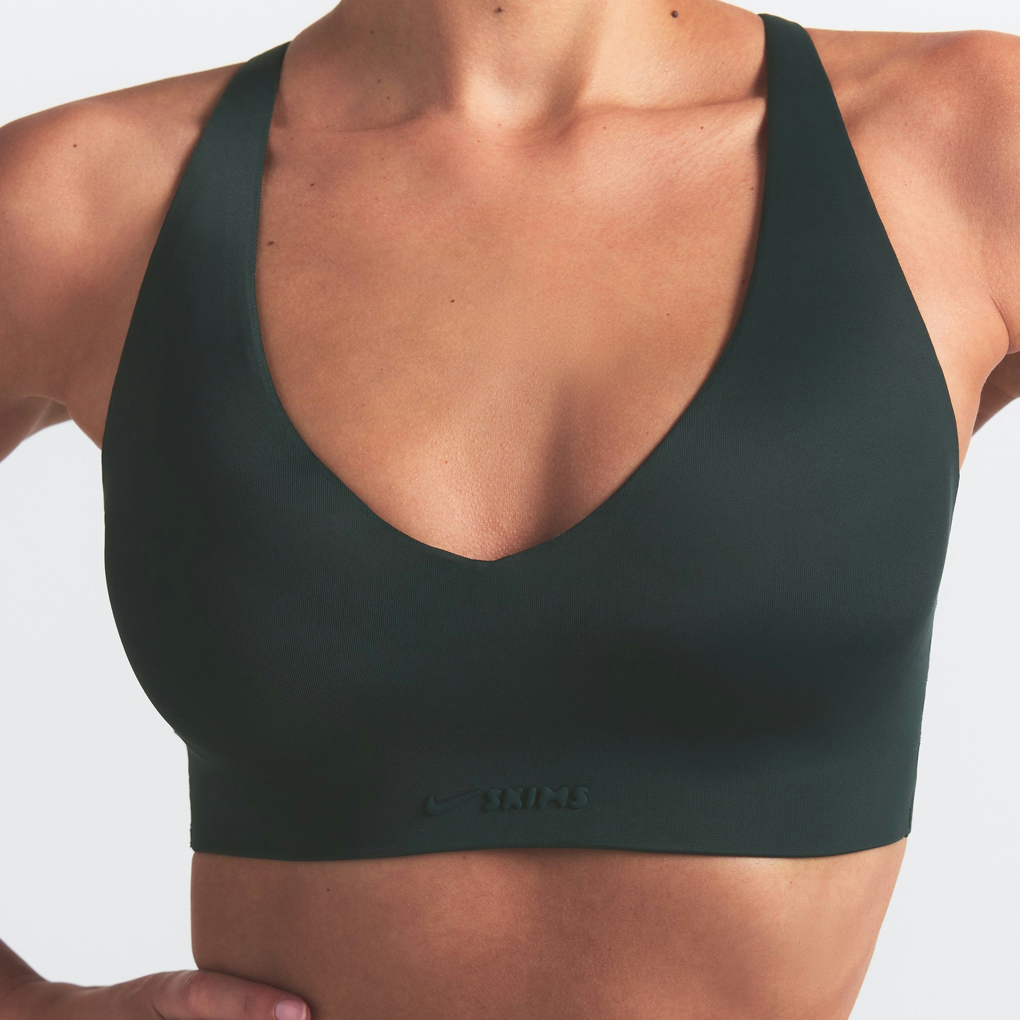 NikeSKIMS SHINE V-NECK BRA | DARK TEAL ON A MODEL SIDE VIEW @ | FOCUS: 0.0, 1.0, 0.9