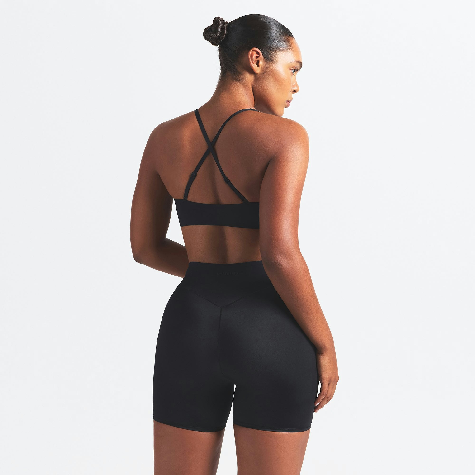 NikeSKIMS SHINE V-NECK BRA | OBSIDIAN ON A MODEL SIDE VIEW