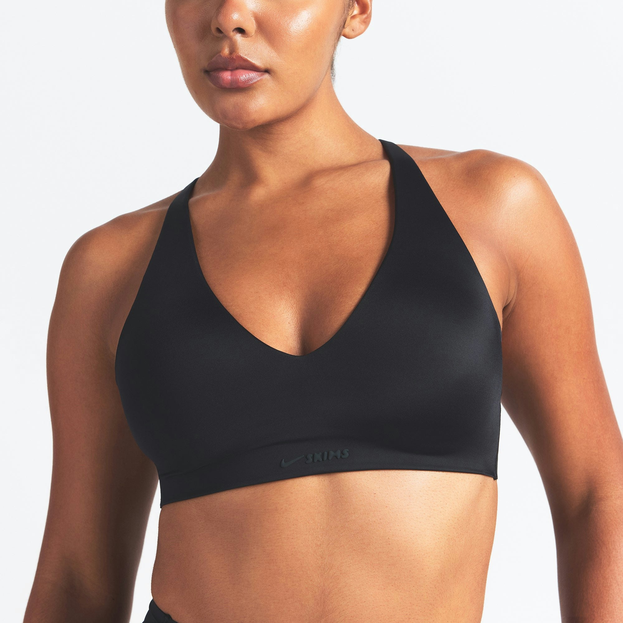 NikeSKIMS SHINE V-NECK BRA | OBSIDIAN ON A MODEL SIDE VIEW