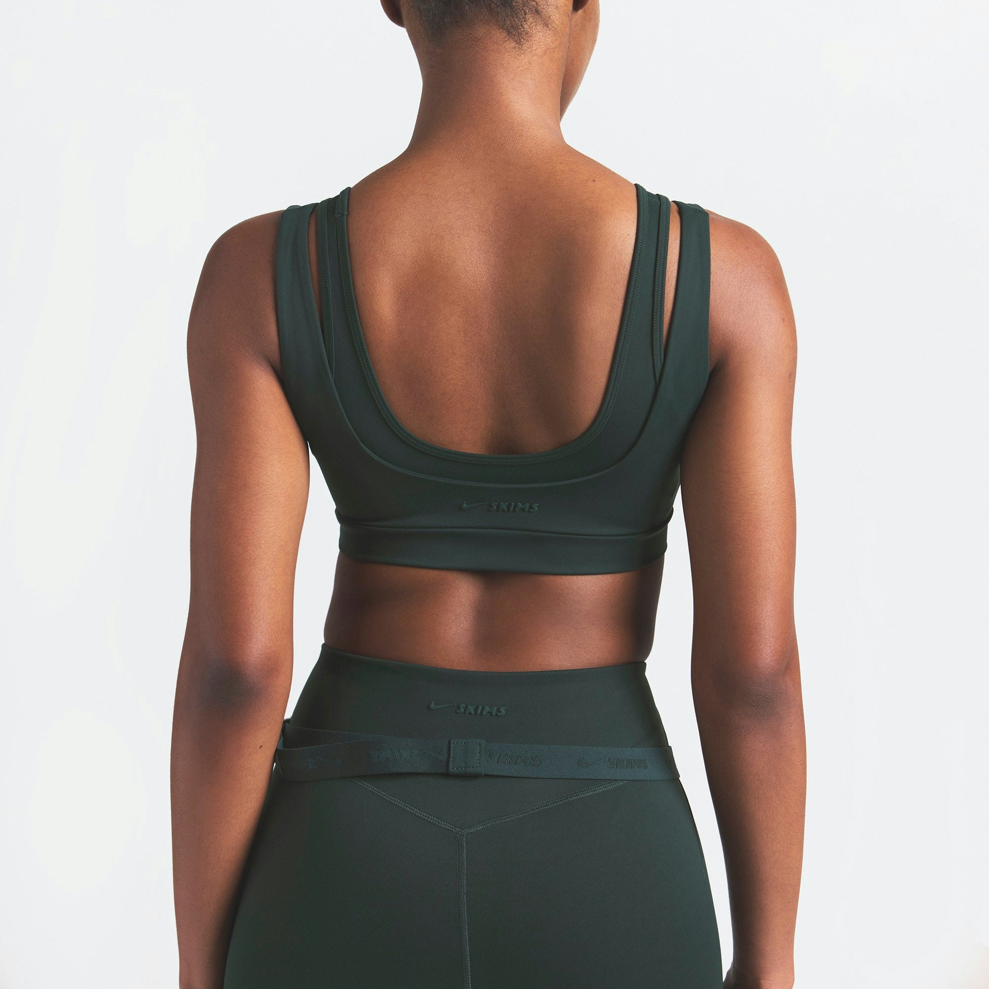 NikeSKIMS MATTE DOUBLE STRAP SCOOP BRA | DARK TEAL ON A MODEL SIDE VIEW @ | FOCUS: 0.0, 1.0, 0.9