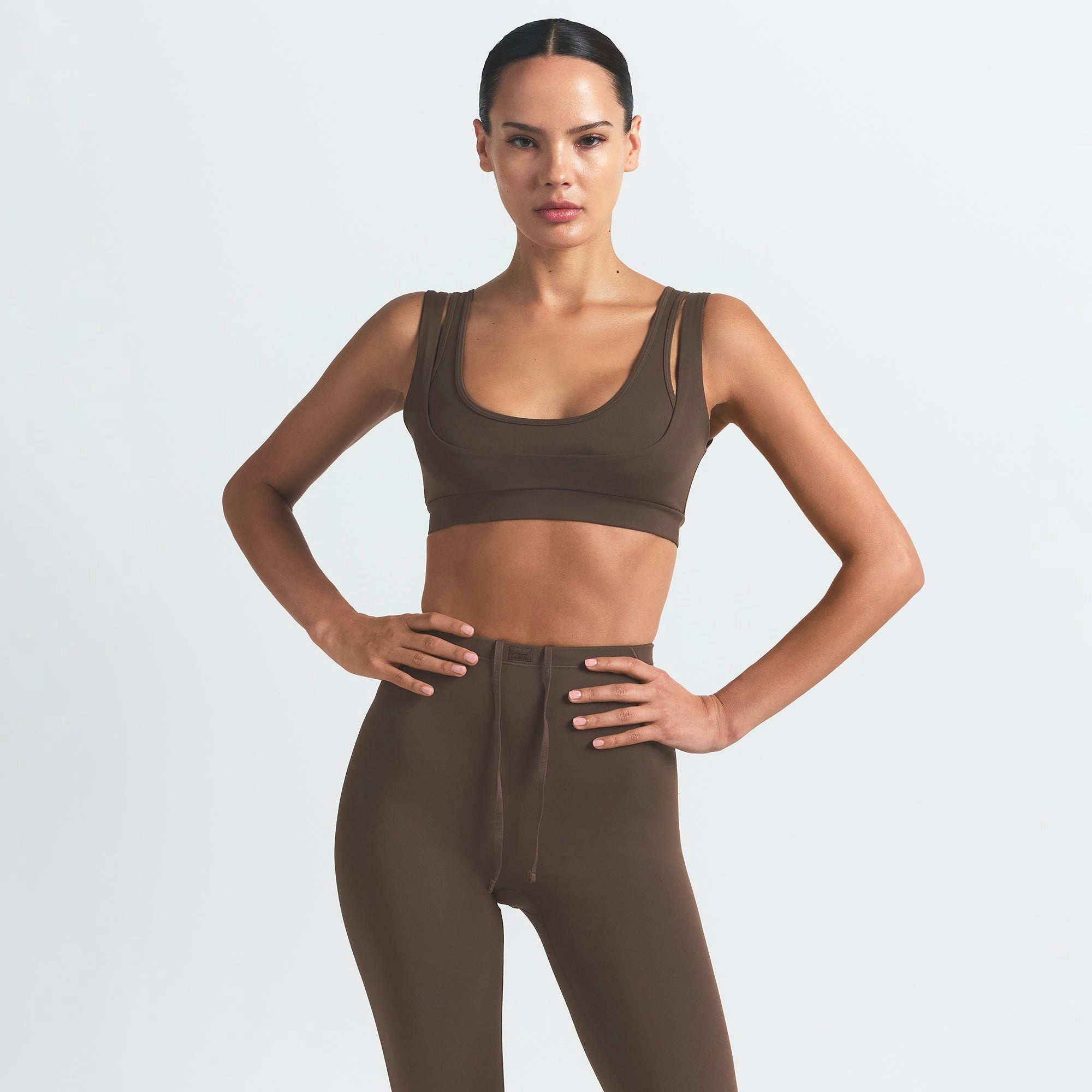NikeSKIMS MATTE DOUBLE STRAP SCOOP BRA | DARK SEPIA ON A MODEL FRONT VIEW