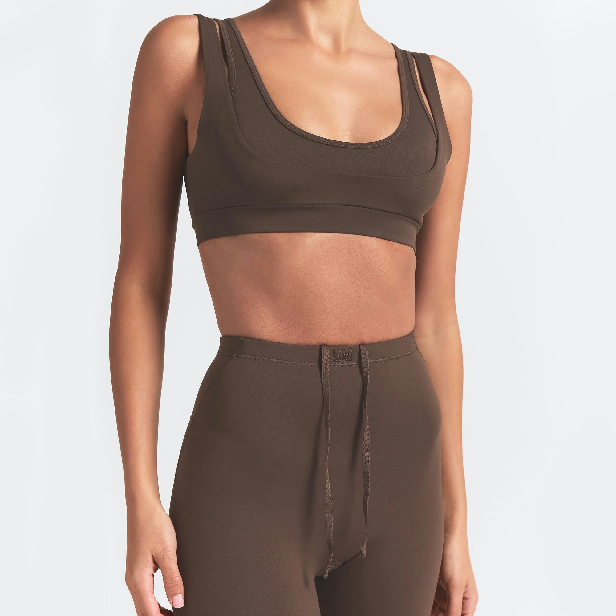 NikeSKIMS MATTE DOUBLE STRAP SCOOP BRA | DARK SEPIA ON A MODEL FRONT VIEW
