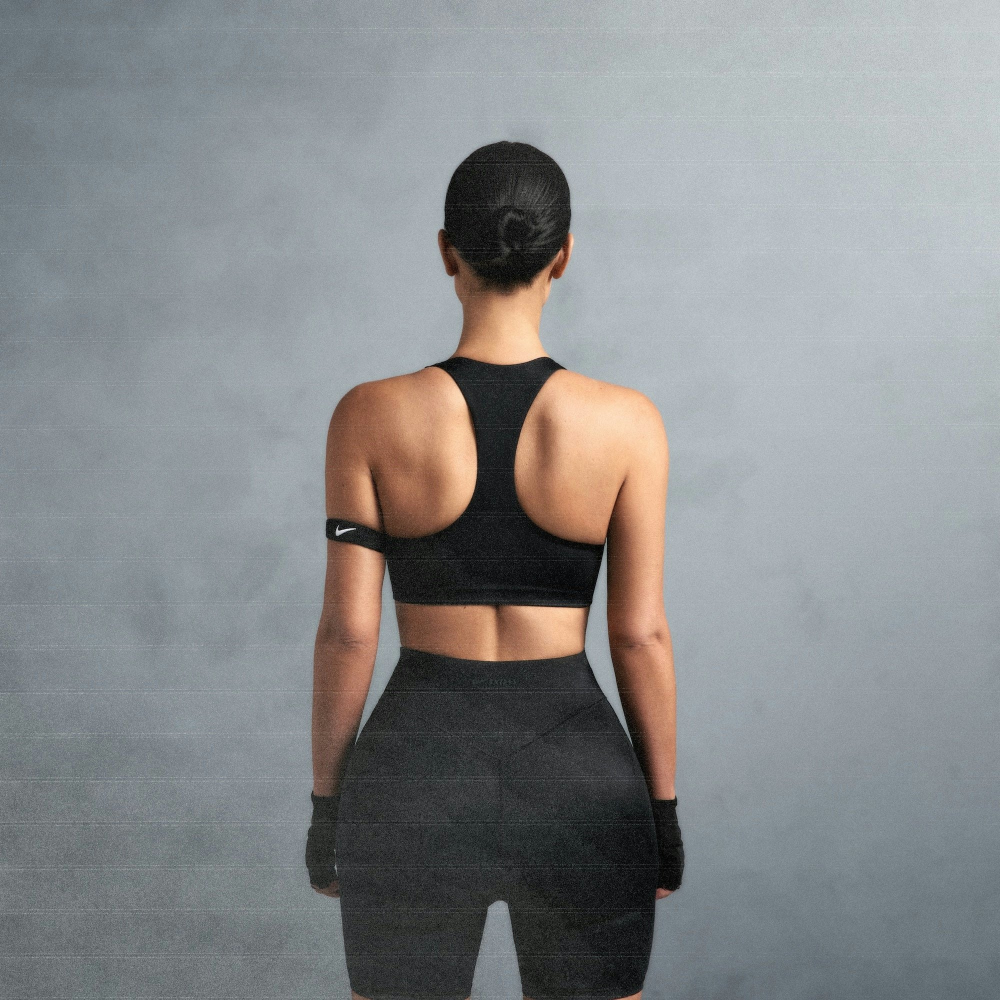 NikeSKIMS SHINE RACER BACK BRA | OBSIDIAN ON A MODEL SIDE VIEW @ | FOCUS: 0.0, 1.0, 0.9