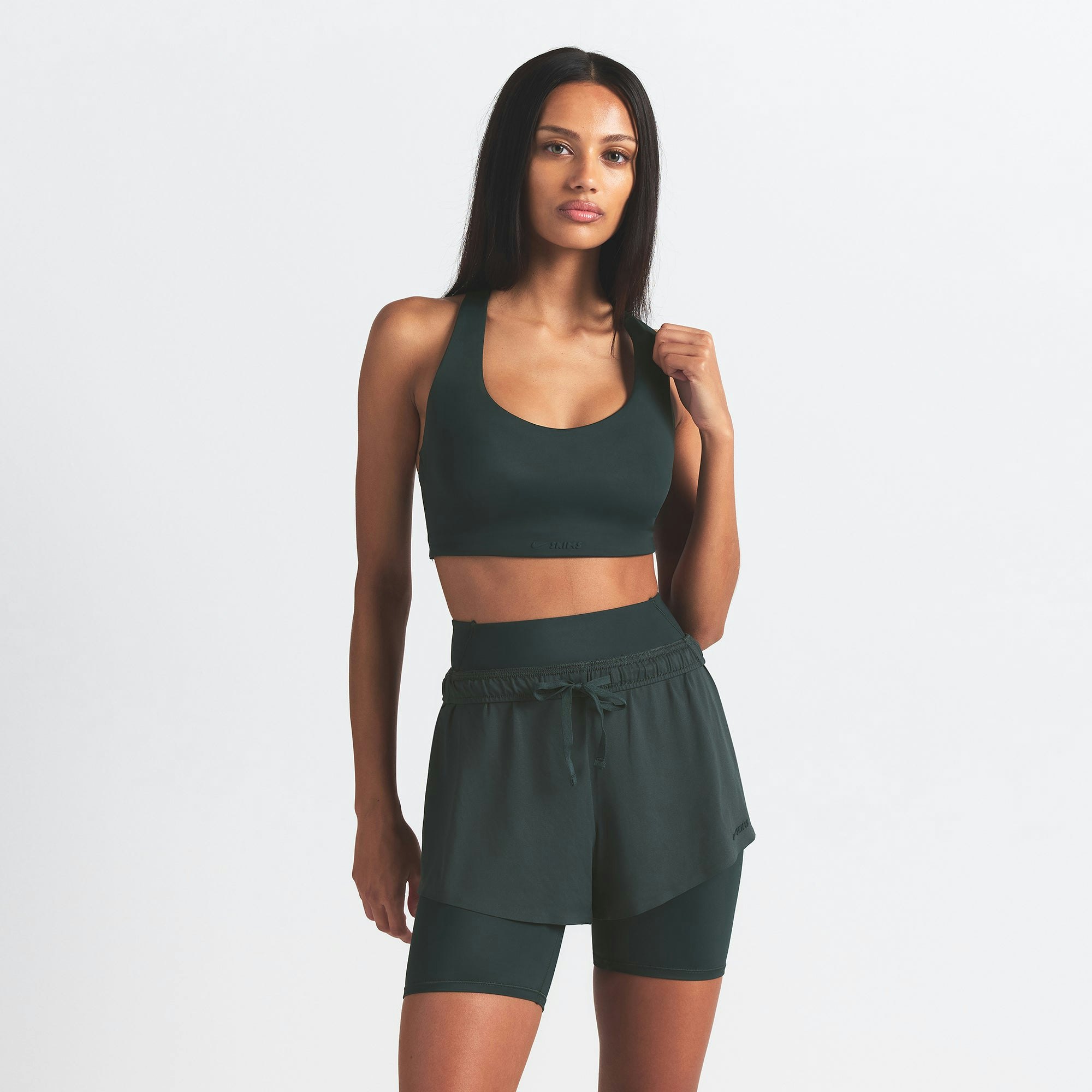 NikeSKIMS SHINE RACER BACK BRA | DARK TEAL ON A MODEL SIDE VIEW @ | FOCUS: 0.0, 1.0, 0.9