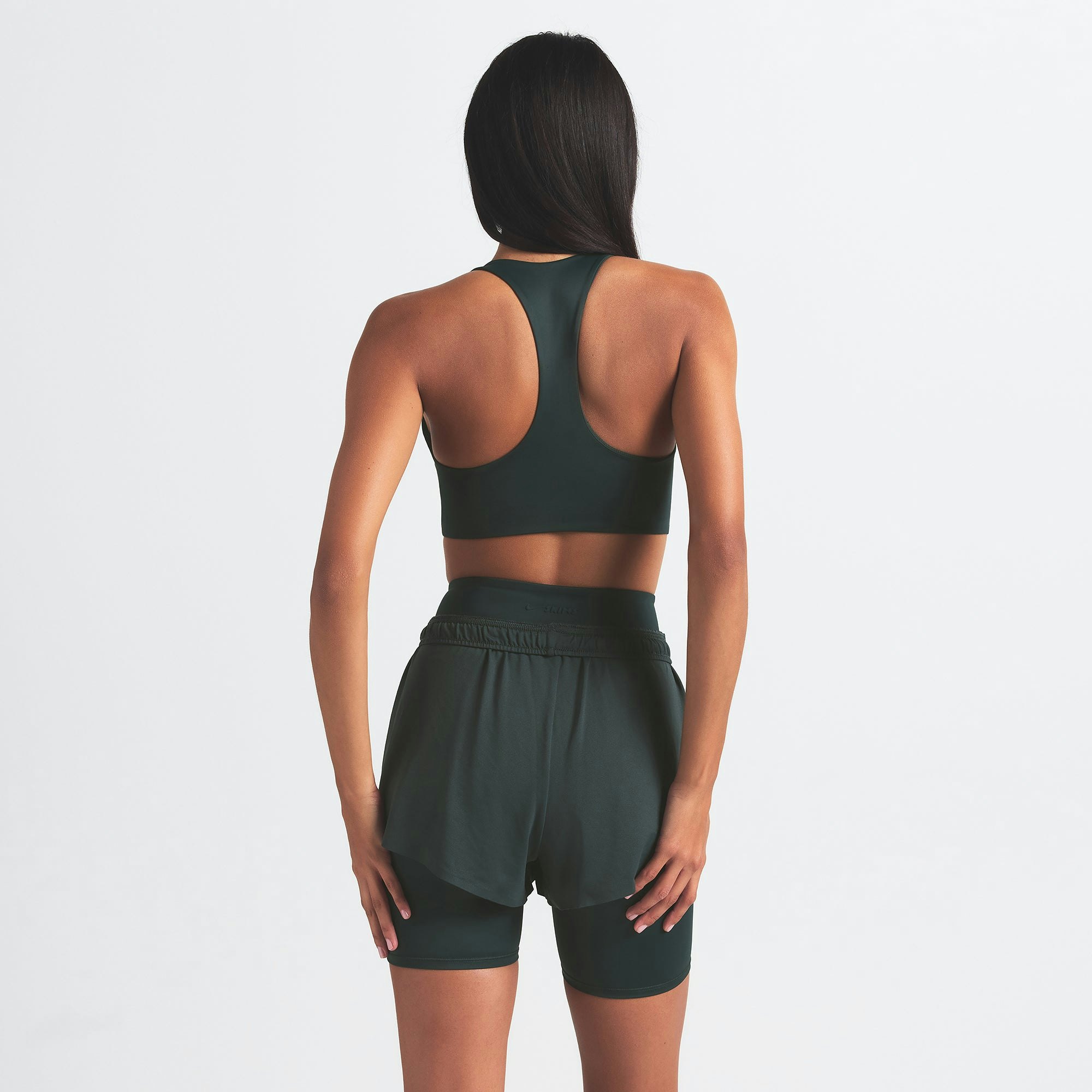 NikeSKIMS SHINE RACER BACK BRA | DARK TEAL ON A MODEL SIDE VIEW @ | FOCUS: 0.0, 1.0, 0.9
