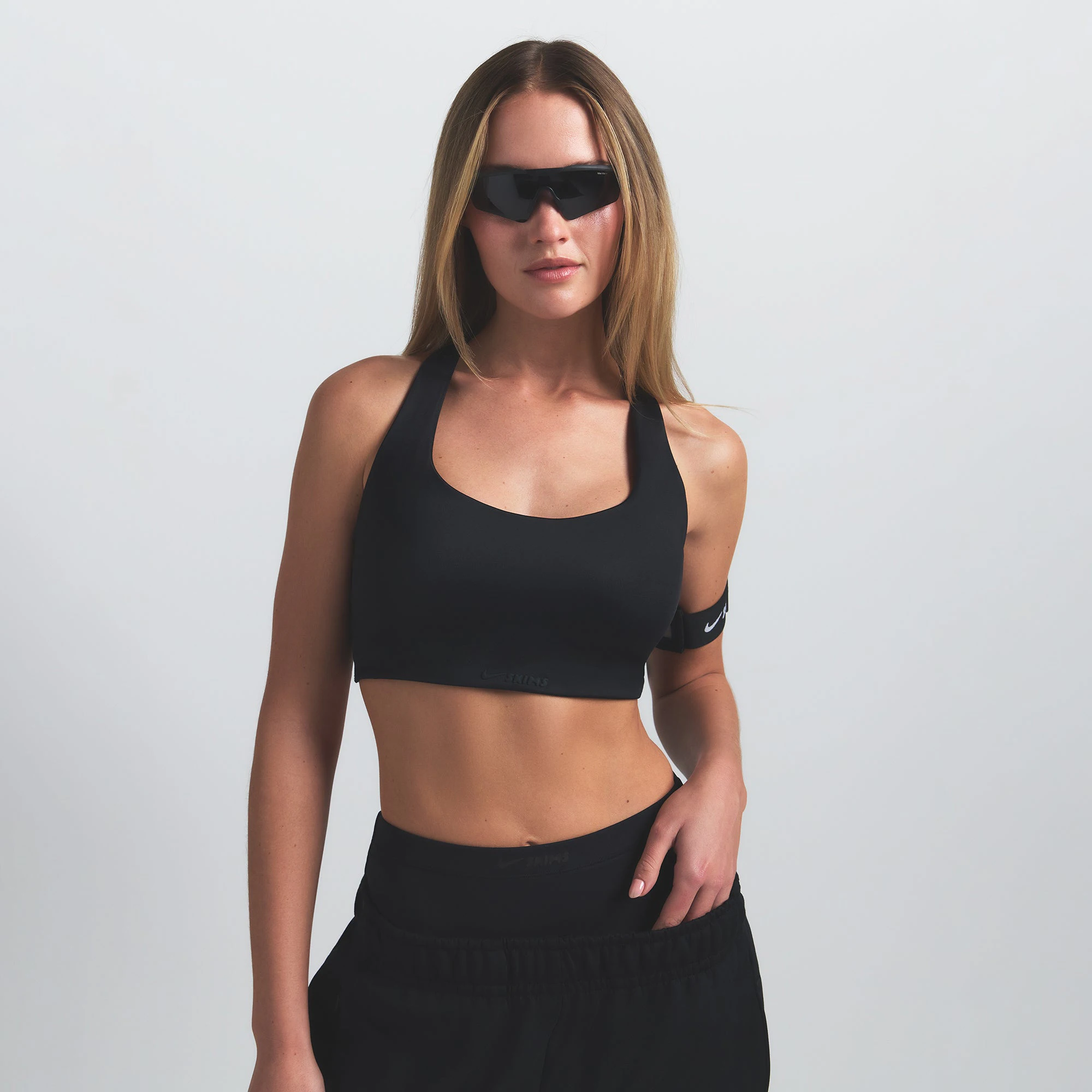 NikeSKIMS SHINE RACER BACK BRA | OBSIDIAN ON A MODEL SIDE VIEW @ | FOCUS: 0.9, 0.1, 0.7