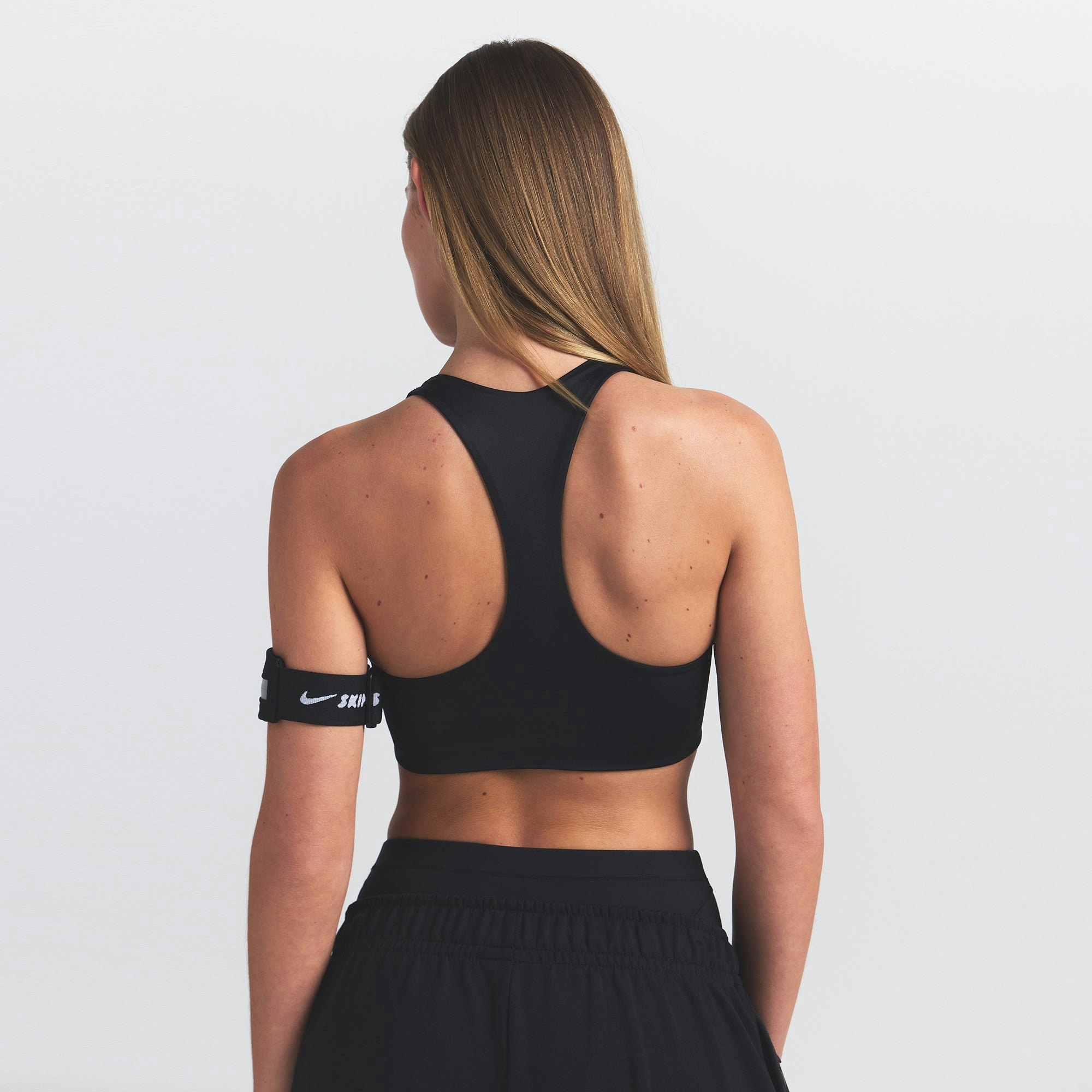 NikeSKIMS SHINE RACER BACK BRA | OBSIDIAN ON A MODEL SIDE VIEW