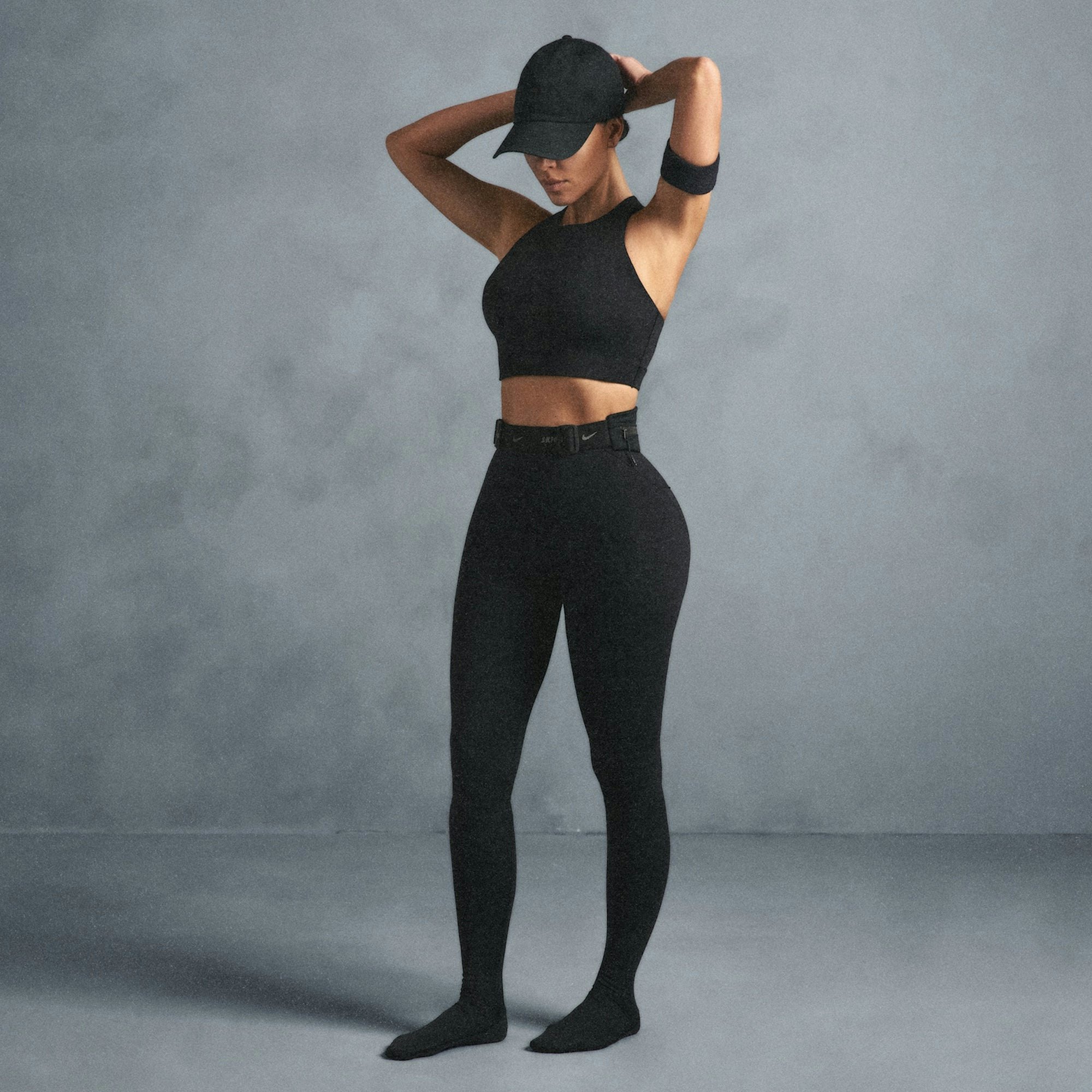 NikeSKIMS SHINE HIGH NECK BRA | OBSIDIAN ON A MODEL SIDE VIEW @ | FOCUS: 0.0, 1.0, 0.9