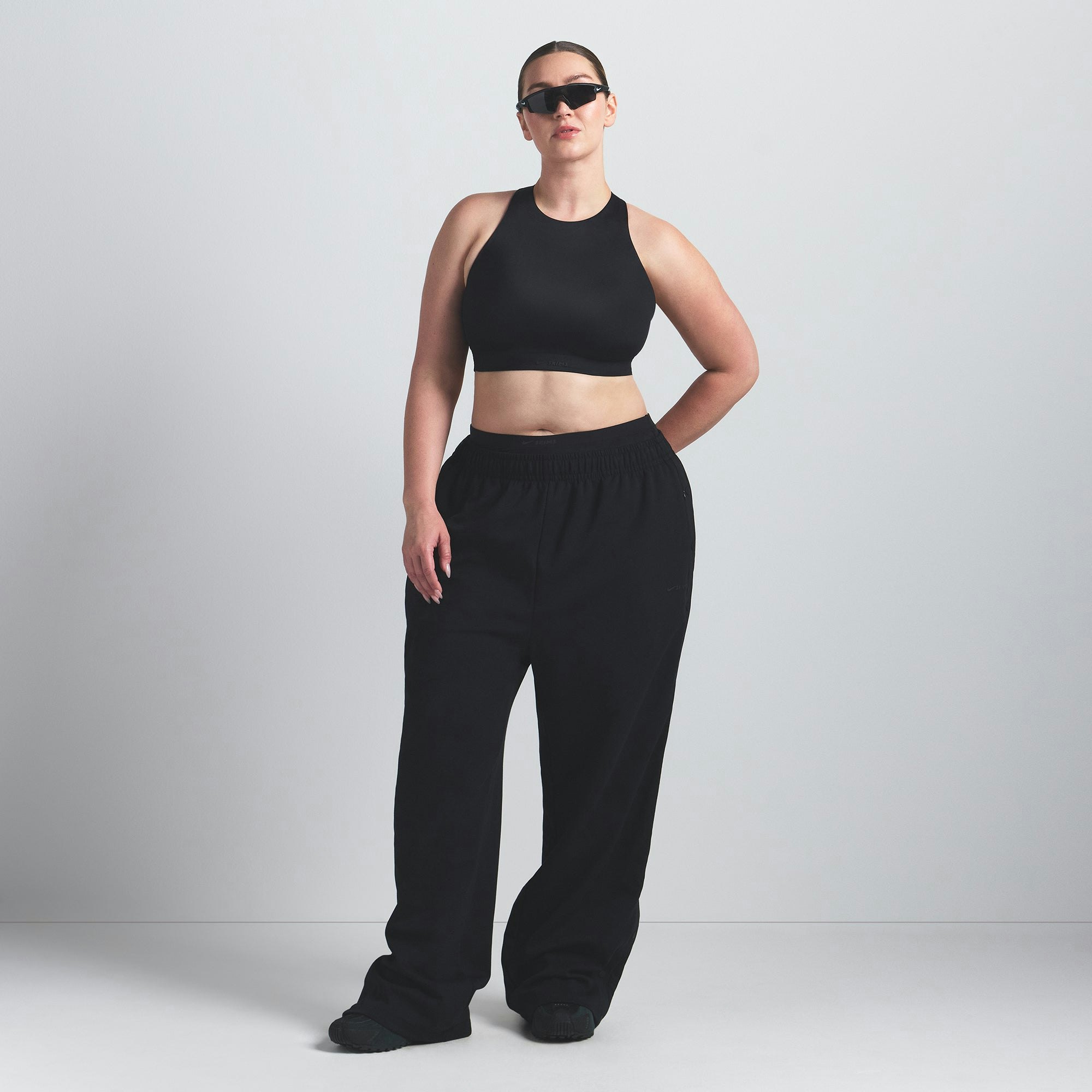 NikeSKIMS SHINE HIGH NECK BRA | OBSIDIAN ON A MODEL FRONT VIEW @ | FOCUS: 0.9, 0.1, 0.7