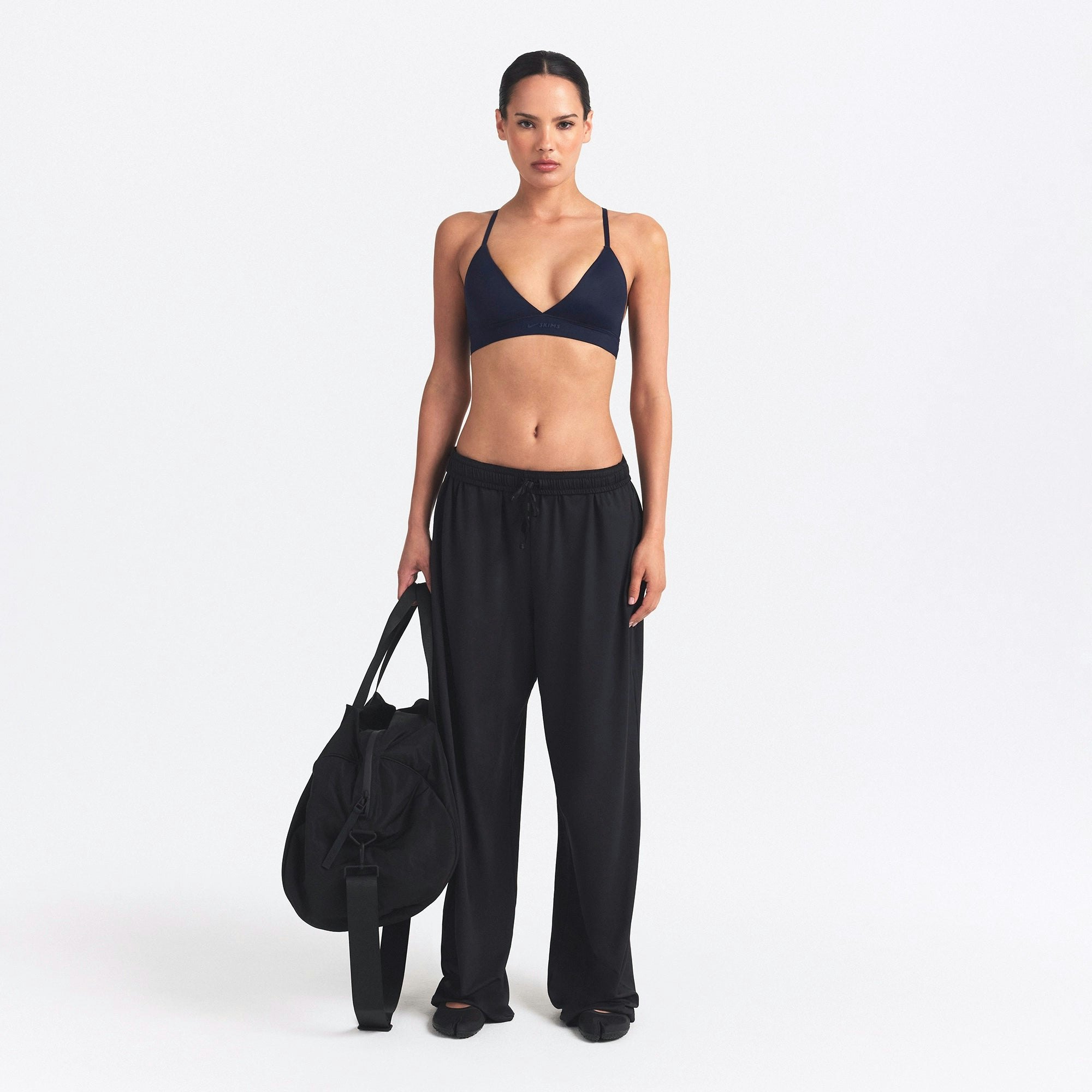 NikeSKIMS SHINE TRIANGLE BRA | NAVY ON A MODEL FRONT VIEW @ | FOCUS: 0.0, 1.0, 0.9