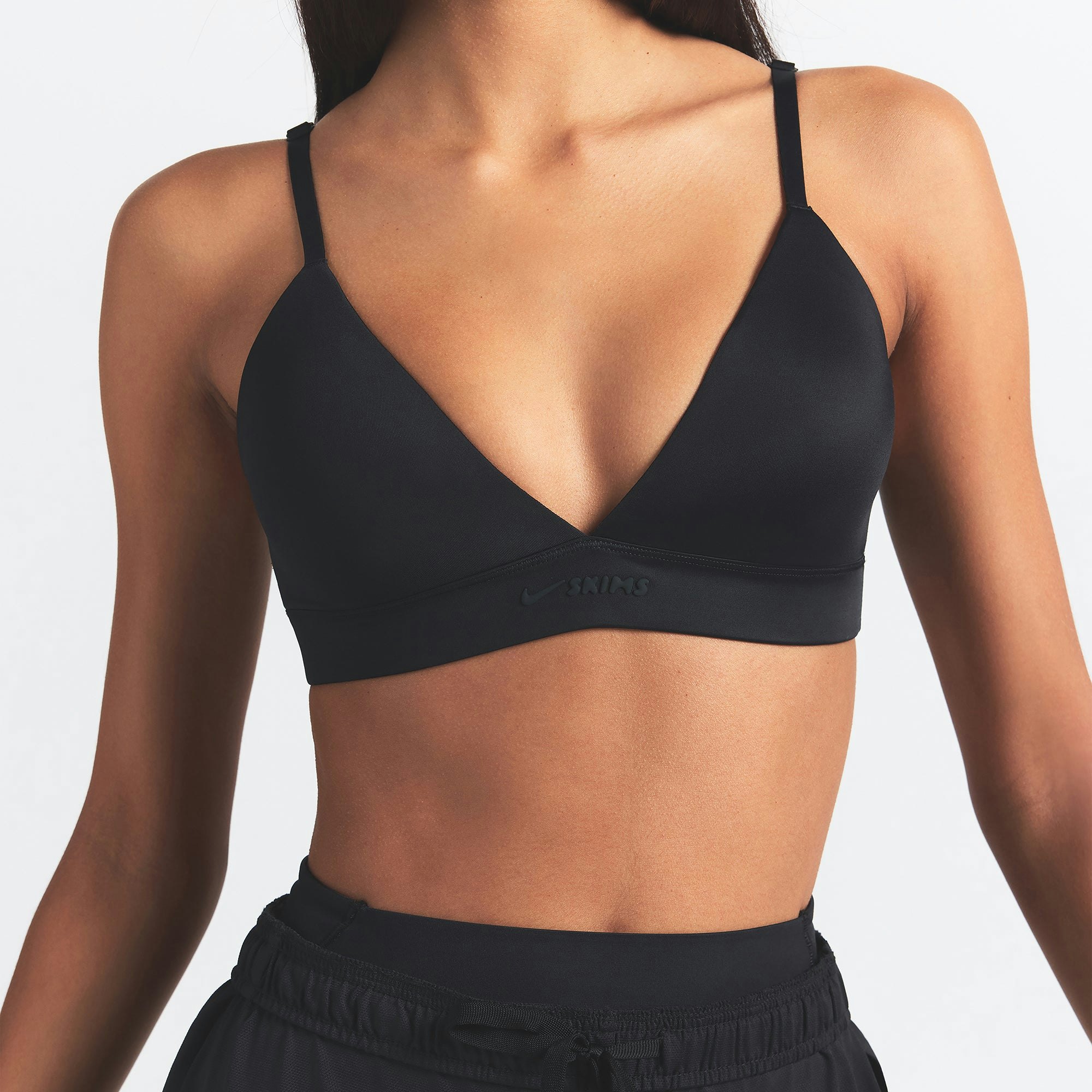 NikeSKIMS SHINE TRIANGLE BRA | OBSIDIAN ON A MODEL SIDE VIEW