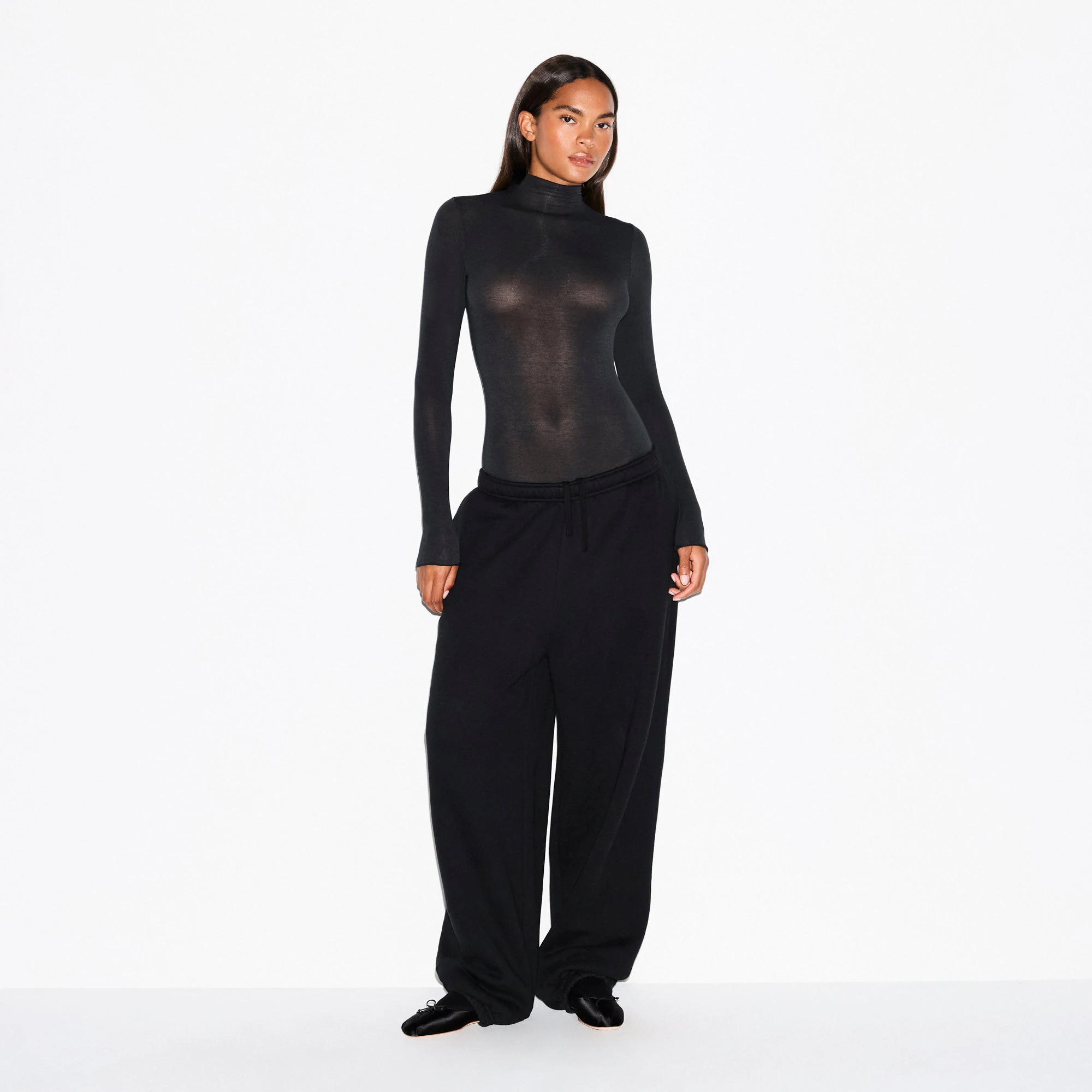 SHEER MODAL LONG SLEEVE TURTLENECK BODYSUIT | ONYX ON A MODEL FRONT VIEW @ | FOCUS: 0.0, 1.0, 0.9