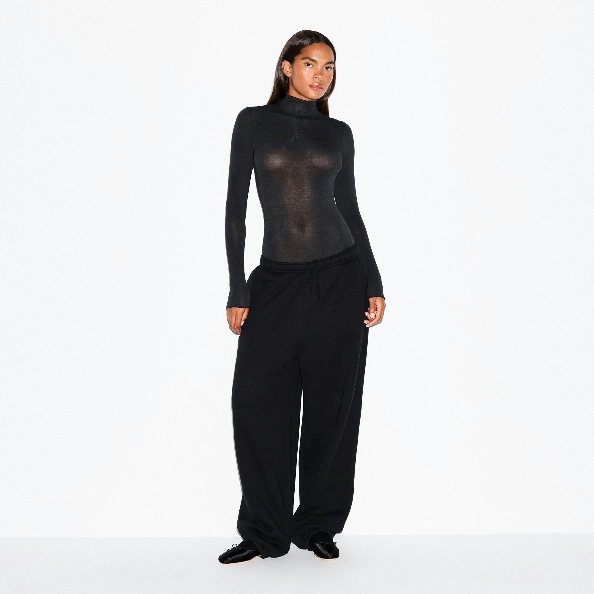SHEER MODAL LONG SLEEVE TURTLENECK BODYSUIT | ONYX ON A MODEL FRONT VIEW @ | FOCUS: 0.0, 1.0, 0.9