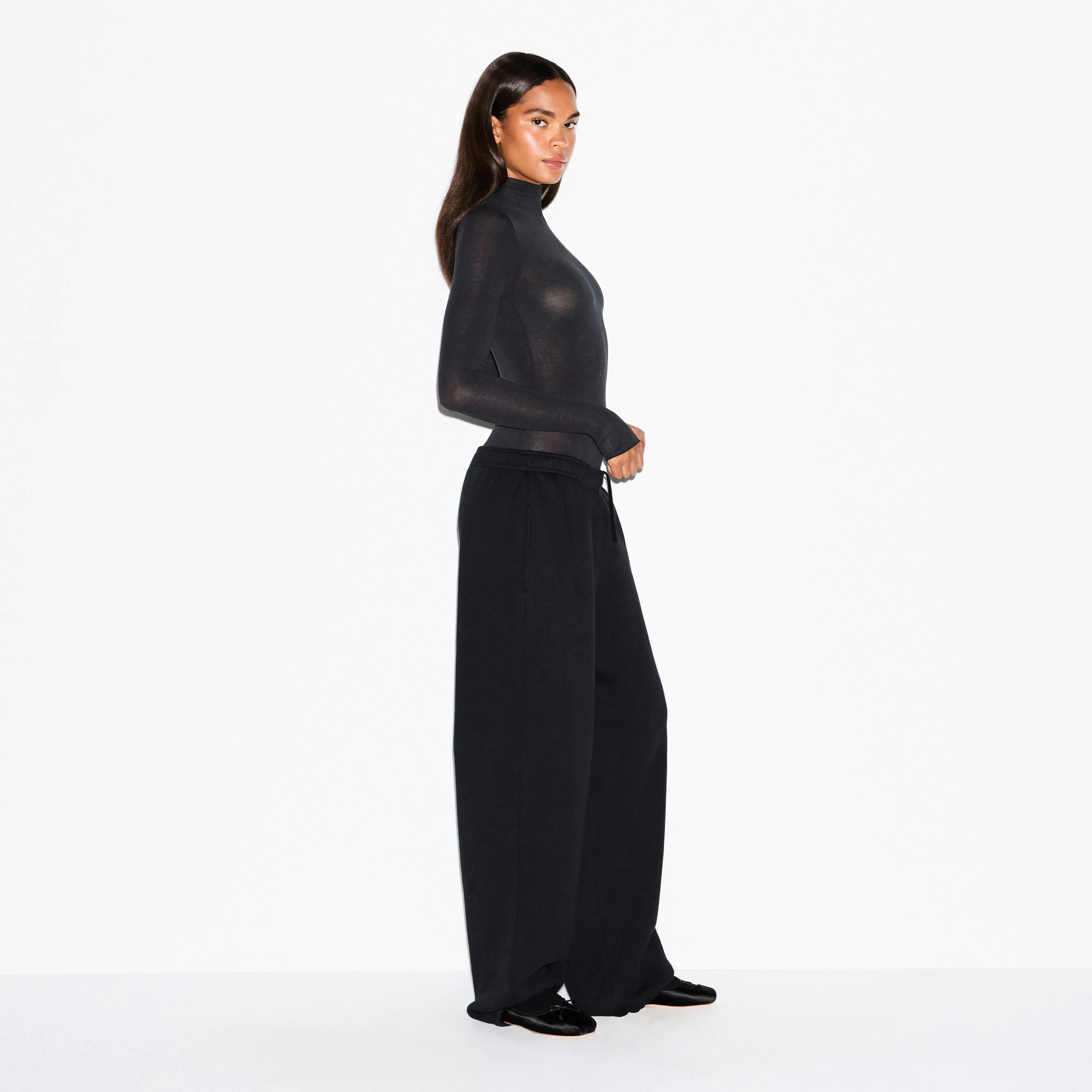 SHEER MODAL LONG SLEEVE TURTLENECK BODYSUIT | ONYX ON A MODEL FRONT VIEW @ | FOCUS: 0.0, 1.0, 0.9