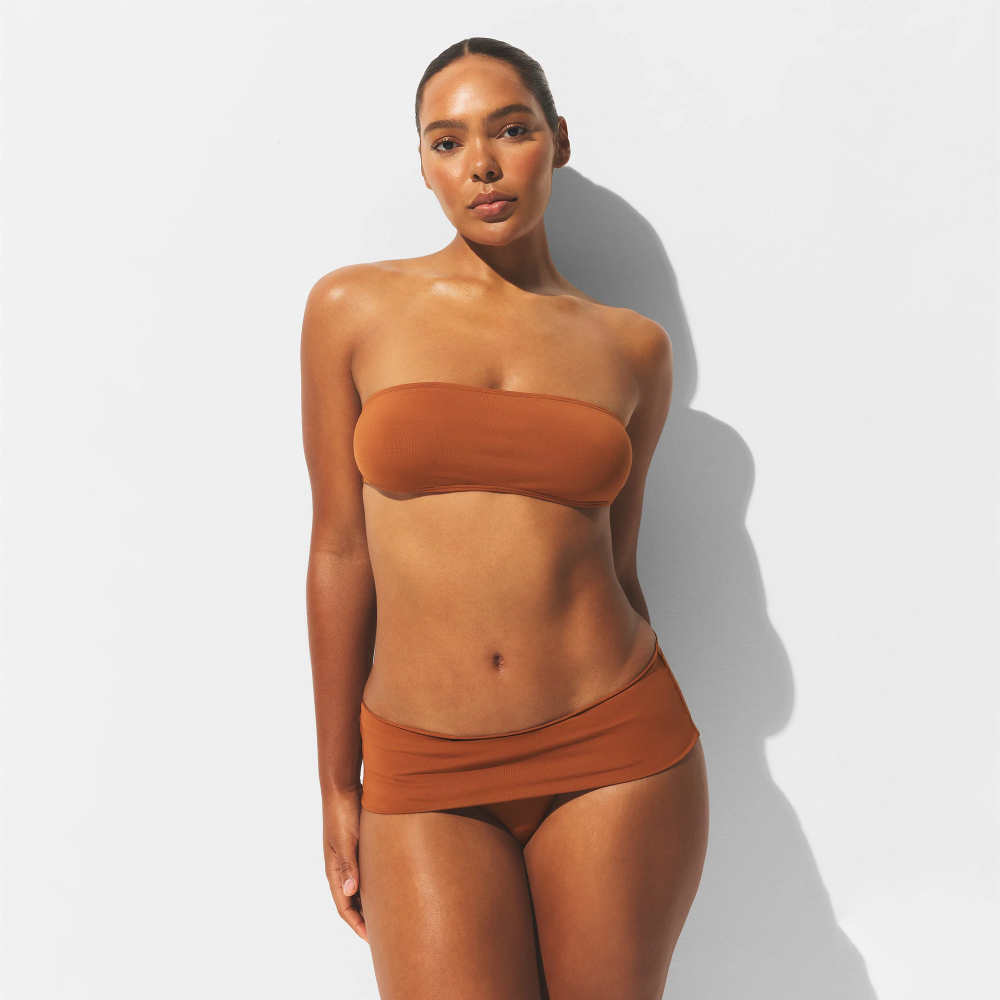 MINIMAL SWIM BANDEAU BIKINI TOP | BRONZE ON A MODEL FRONT VIEW | FOCUS: 0.0, 1.0, 0.9