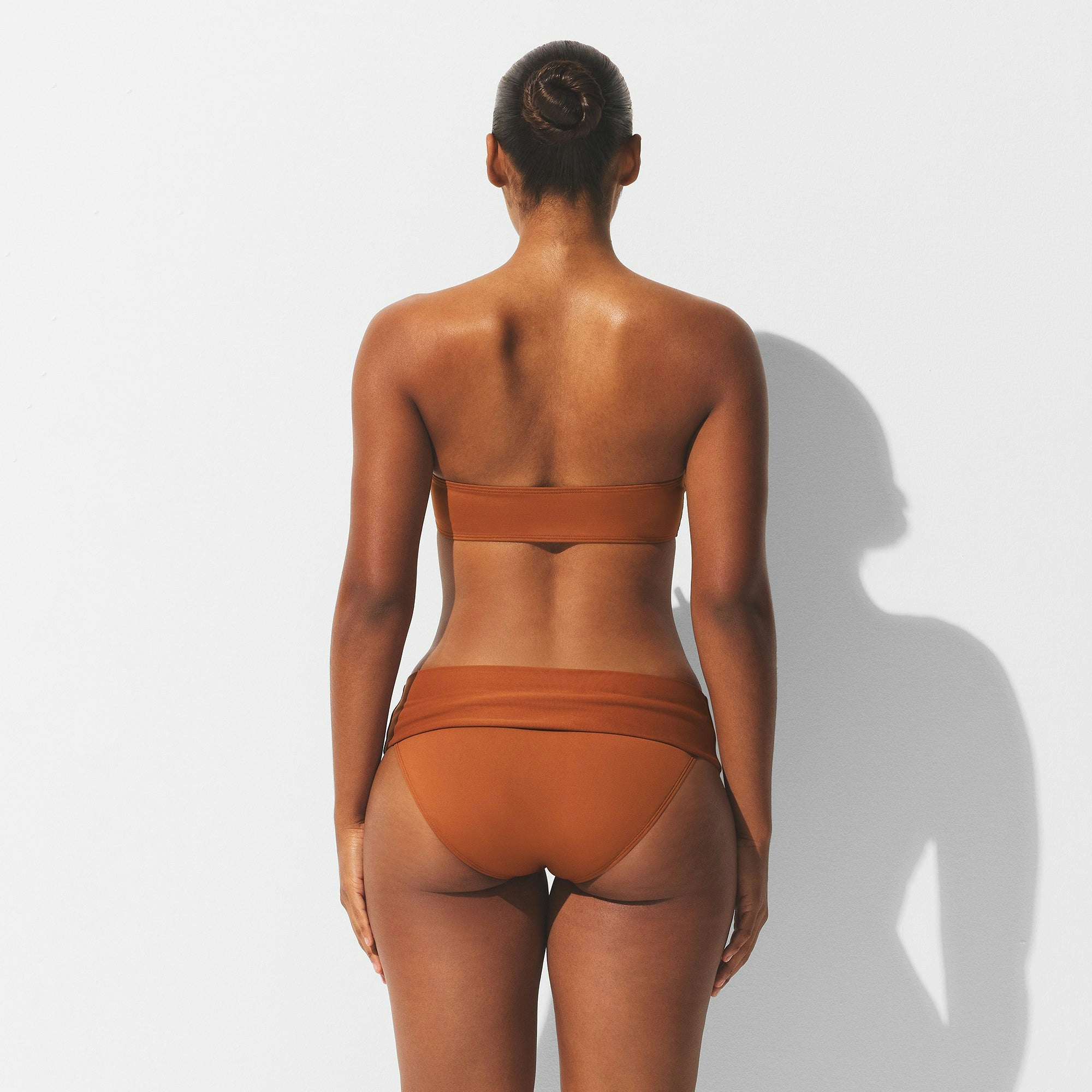 MINIMAL SWIM BANDEAU BIKINI TOP | BRONZE ON A MODEL BACK VIEW | FOCUS: 0.0, 1.0, 0.9