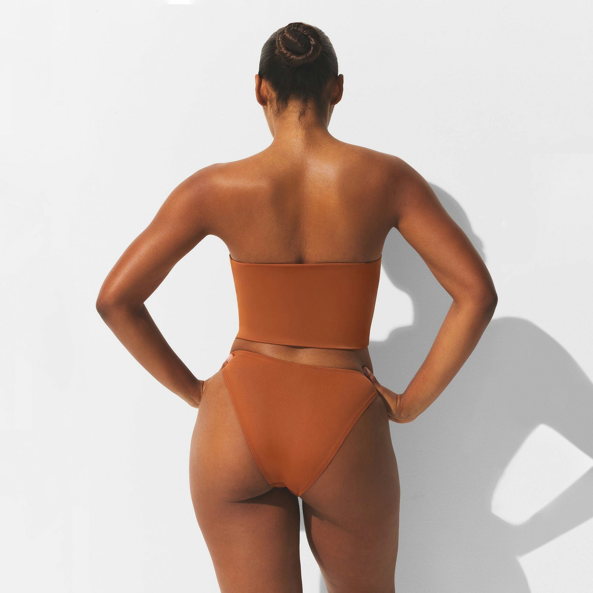 MINIMAL SWIM CONVERTIBLE BANDEAU BIKINI TOP | BRONZE ON A MODEL BACK VIEW | FOCUS: 0.0, 1.0, 0.9