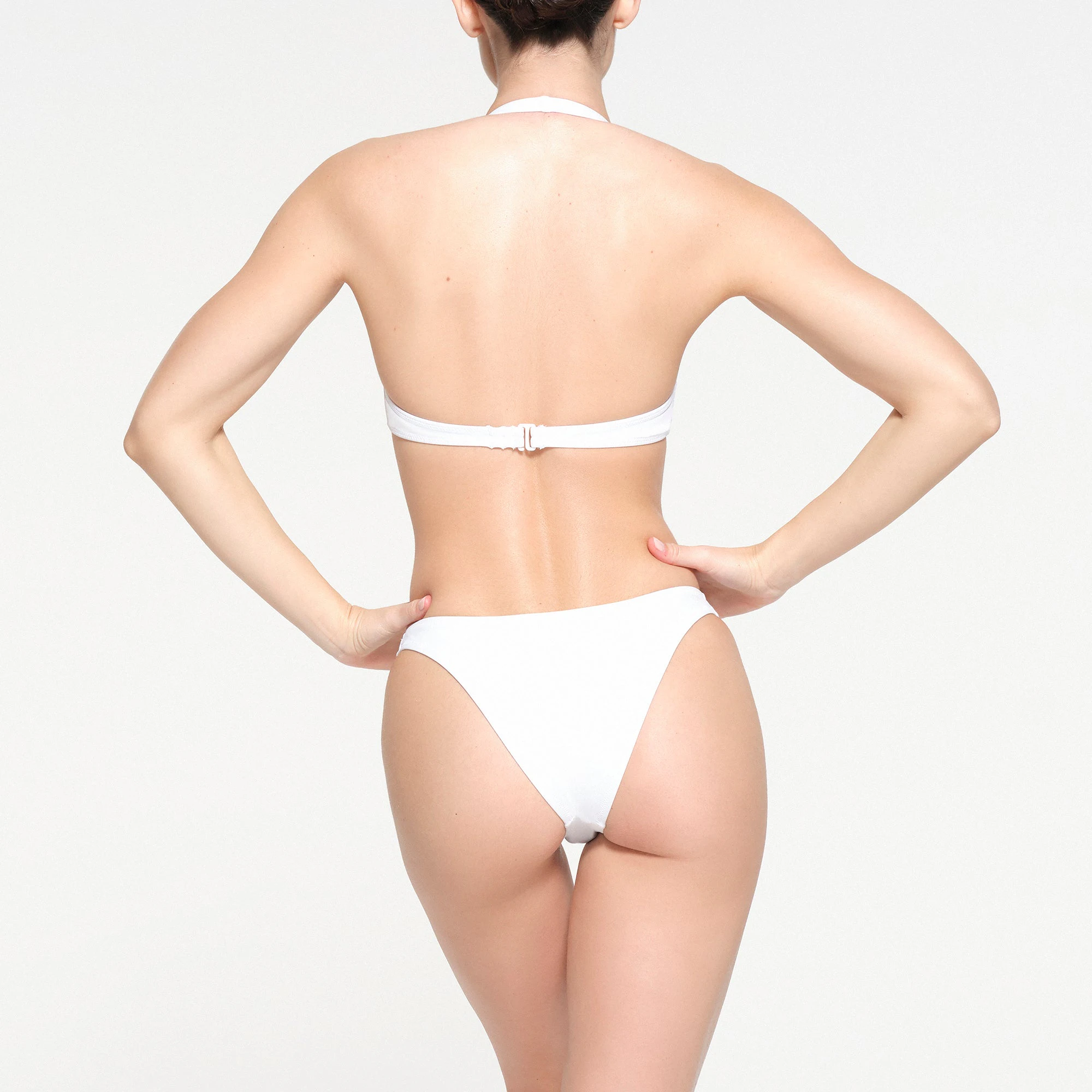 SIGNATURE SWIM HALTER SCOOP TOP | SNOW ON A MODEL BACK VIEW
