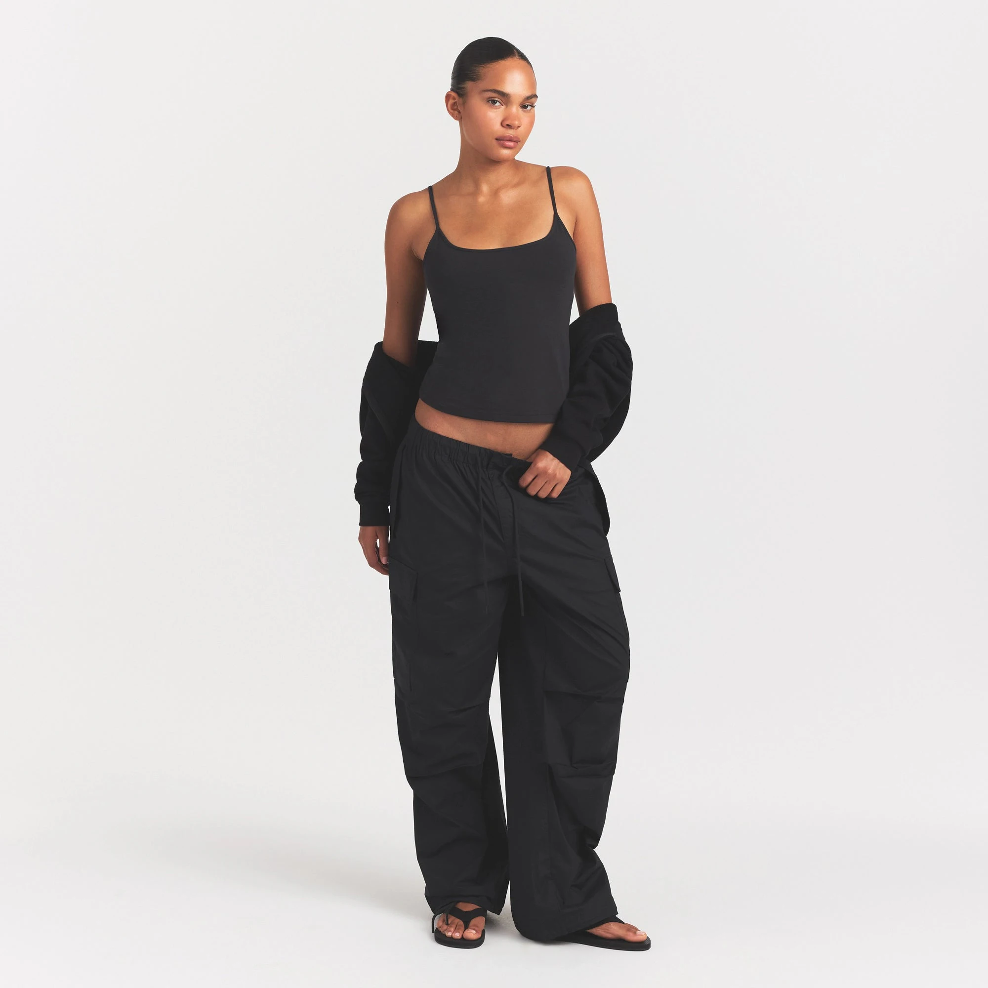 WOVEN COTTON OVERSIZED LOW RISE CARGO PANT | ONYX ON A MODEL FRONT VIEW @ | FOCUS: 0.0, 1.0, 0.9