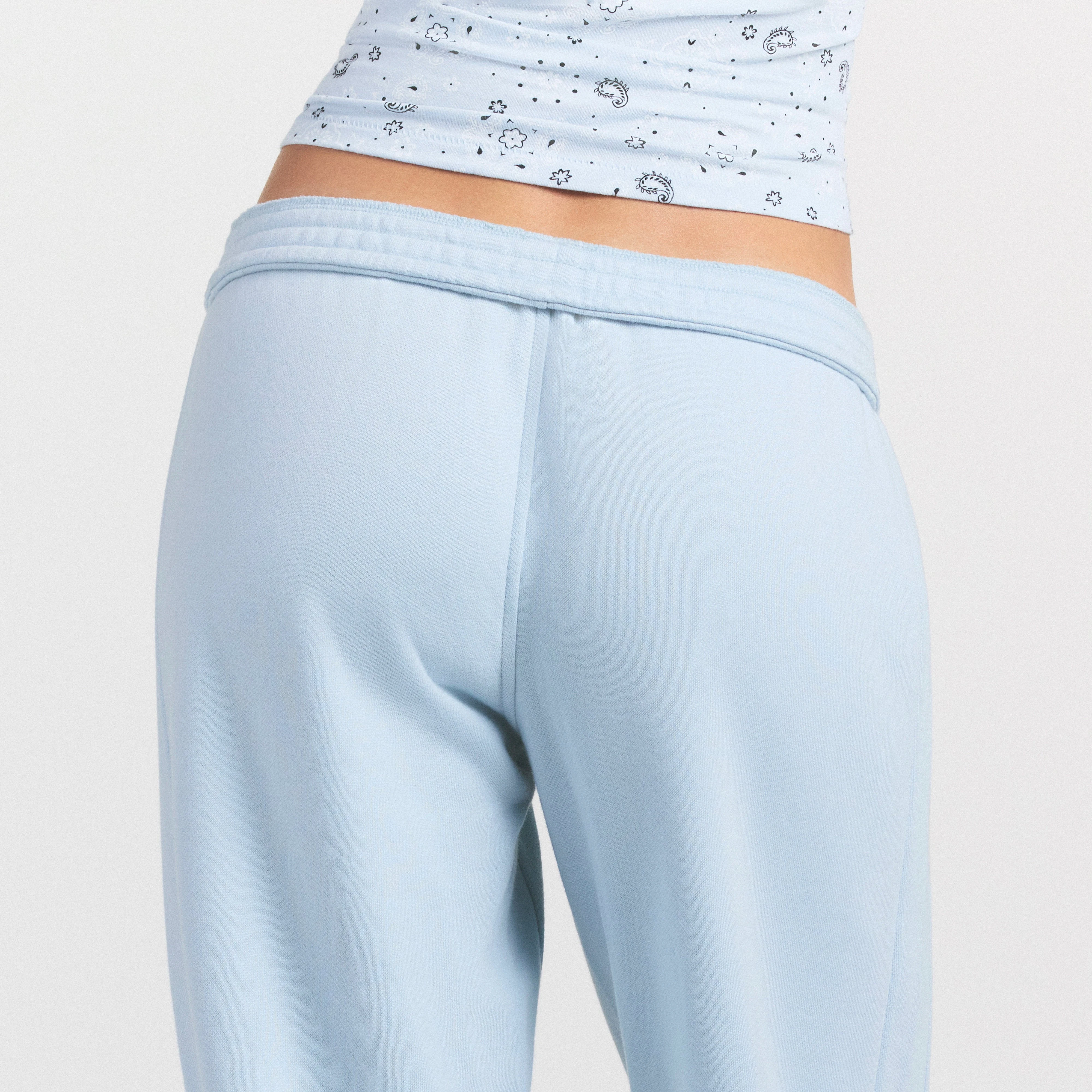 DRAPEY FRENCH TERRY CROPPED JOGGER | POWDER BLUE ON A MODEL SIDE VIEW @ | FOCUS: 0.0, 1.0, 0.9