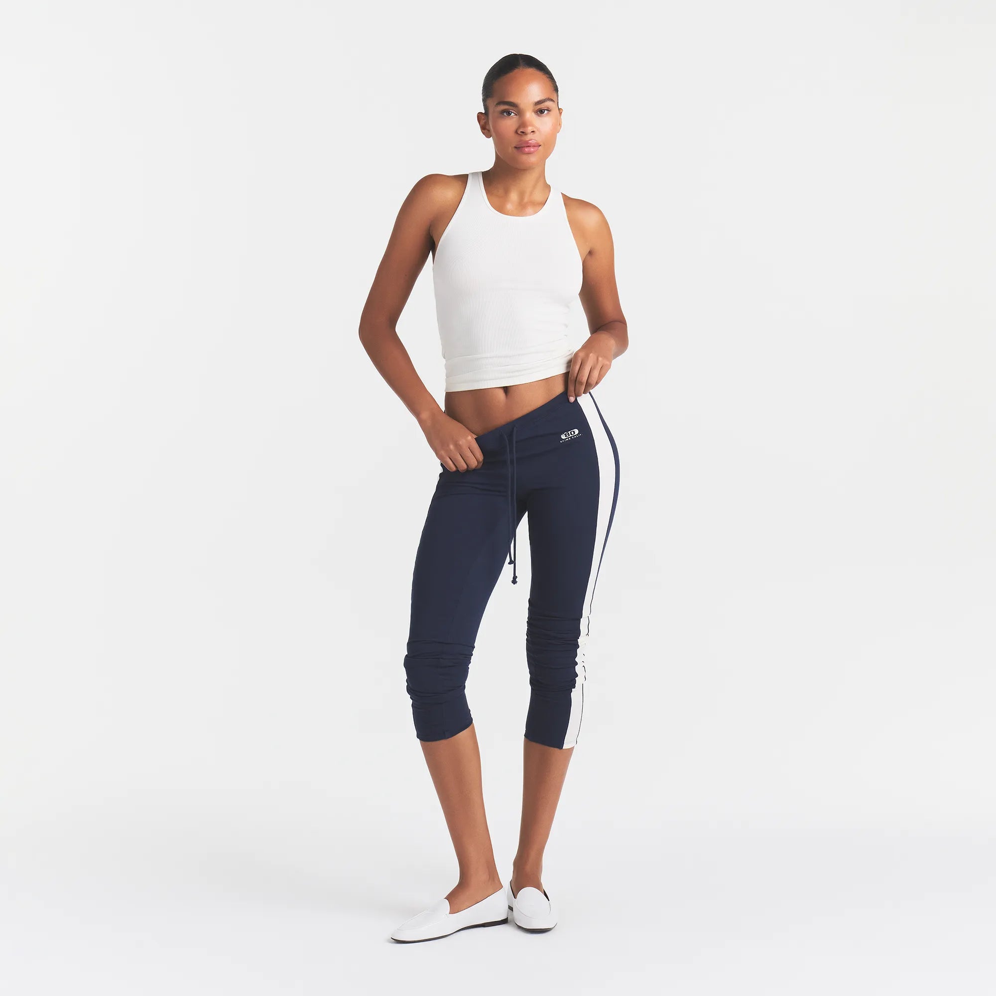 OUTDOOR HIGH-WAISTED LEGGING | NAVY ECRU CONTRAST & LAYS FLAT ON A WHITE BACKGROUND | FLT @ | FOCUS: 0.0, 1.0, 0.9