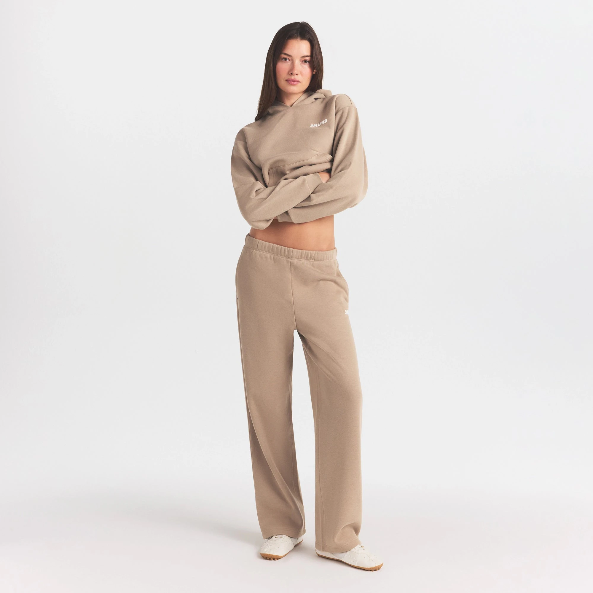 COTTON FLEECE STRAIGHT LEG PANT WITH EMBOSSED LOGO | LATTE ON A MODEL FRONT VIEW @ | FOCUS: 0.0, 1.0, 0.9