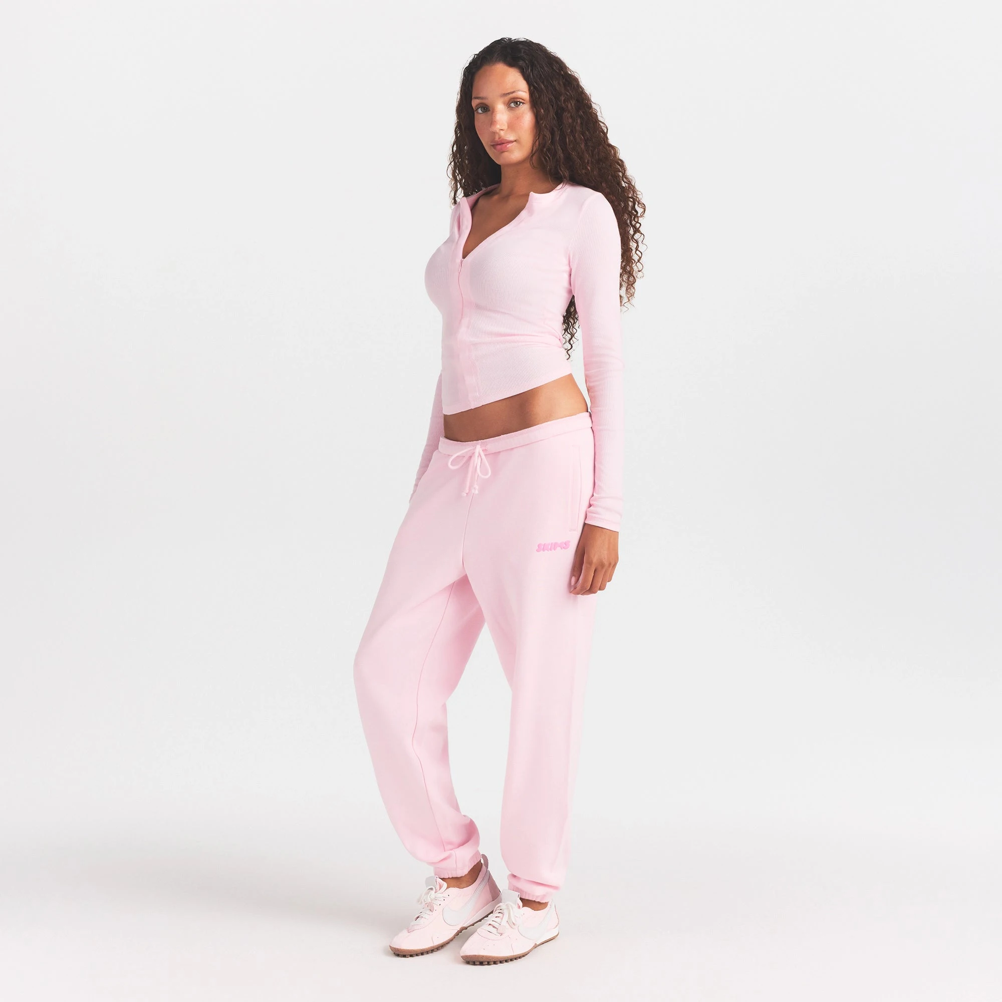 COTTON FLEECE JOGGER WITH EMBOSSED LOGO | CHERRY BLOSSOM ON A MODEL FRONT VIEW @ | FOCUS: 0.0, 1.0, 0.9